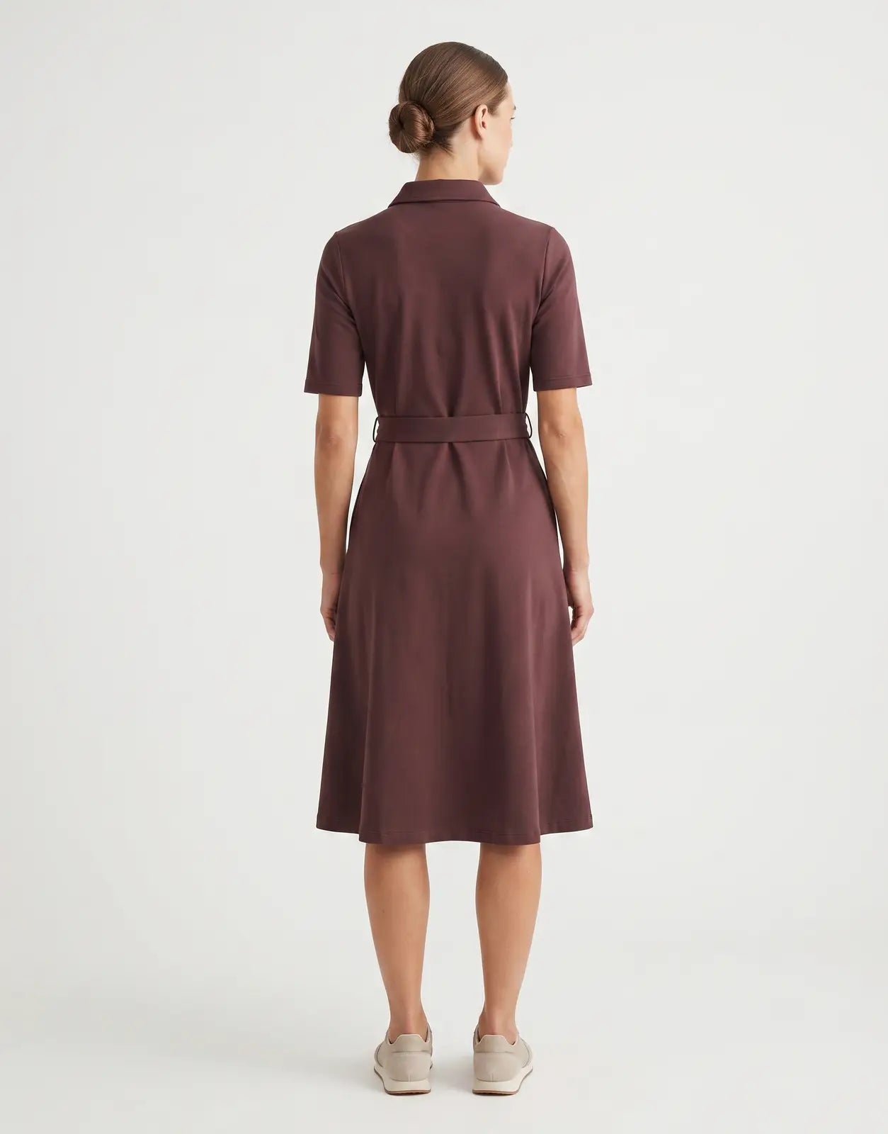 Back view of a Huckleberry Polo Elizabeth Flare Golfer Dress, featuring a collared neckline, short sleeves, and a belted