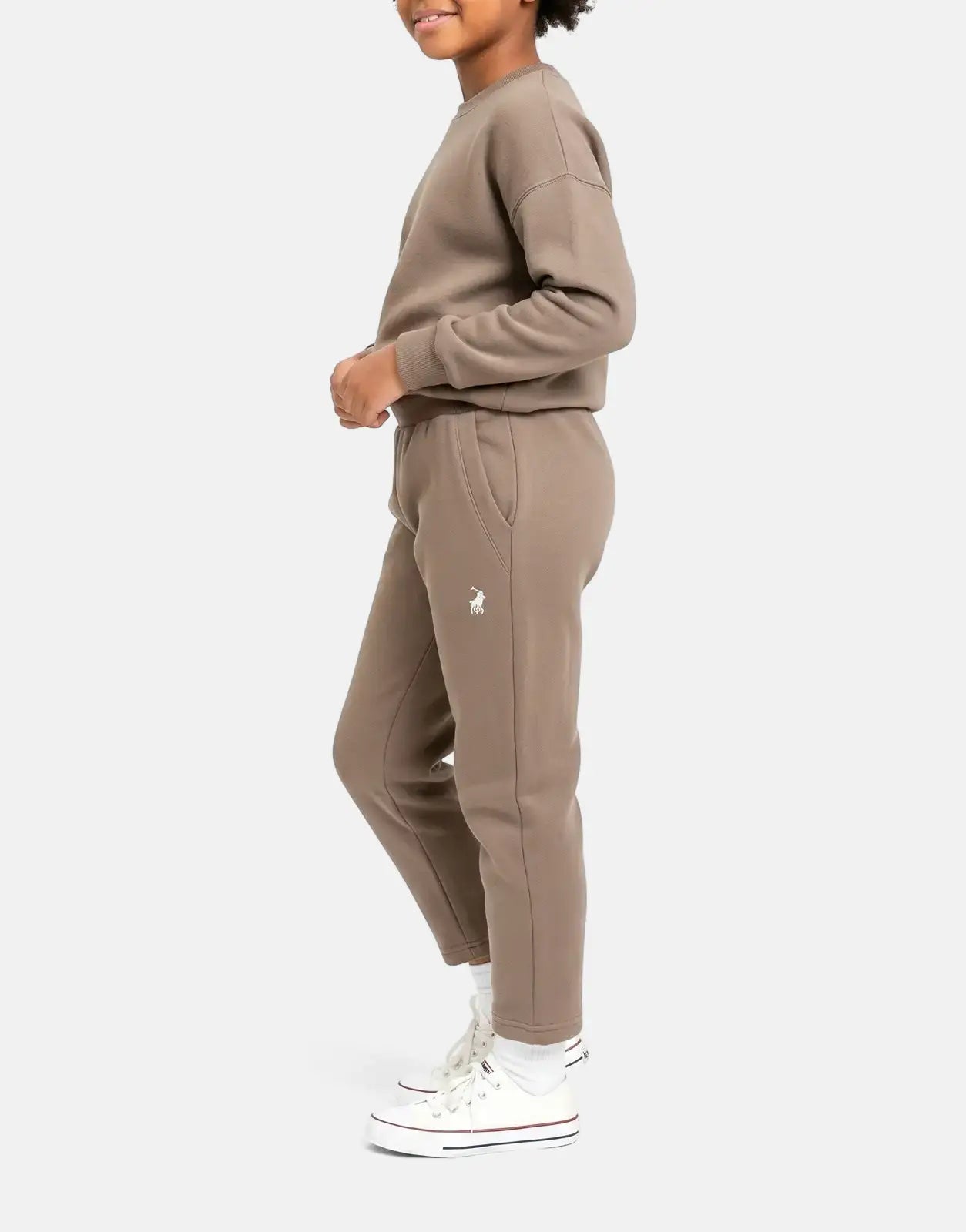 Young girl wears a Polo Girls Kim Pull On Iron Jogger set, featuring a brown sweatshirt and matching joggers with a white
