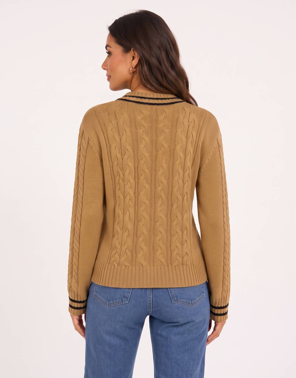 Woman wearing a camel cable knit long sleeve v-neck sweater with black striped collar and cuffs, shown from the back.
