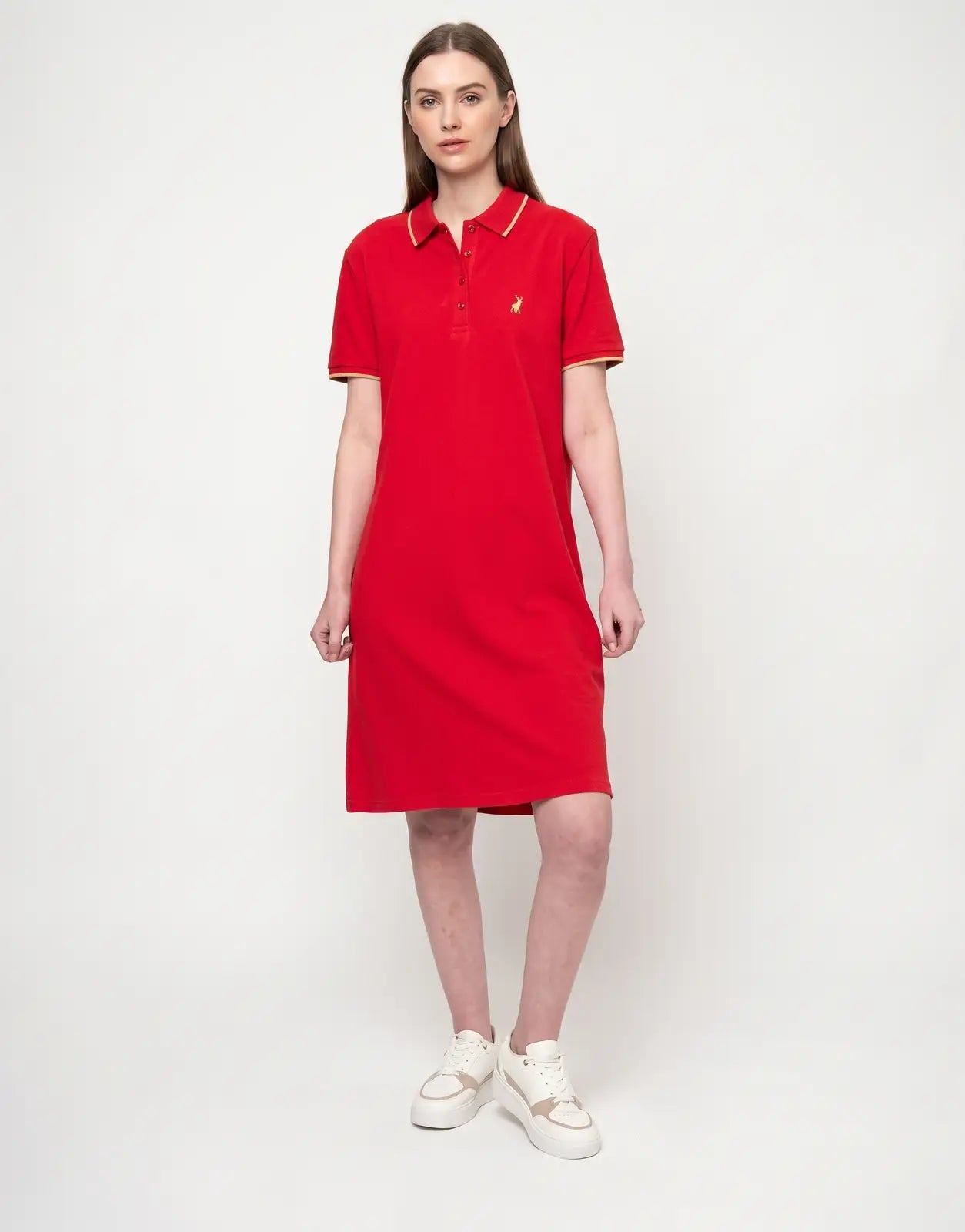 A woman models the Polo Leah Red Golfer Dress, a vibrant red short-sleeved polo dress with a classic collar and embroidered