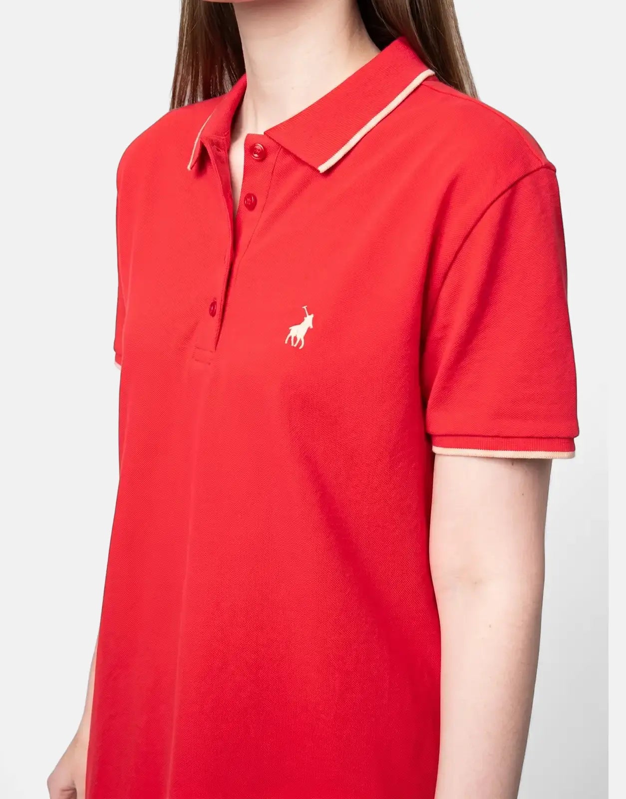 Woman wearing a bright red Polo Leah golfer dress with a white polo logo and contrasting trim on the collar and sleeves,