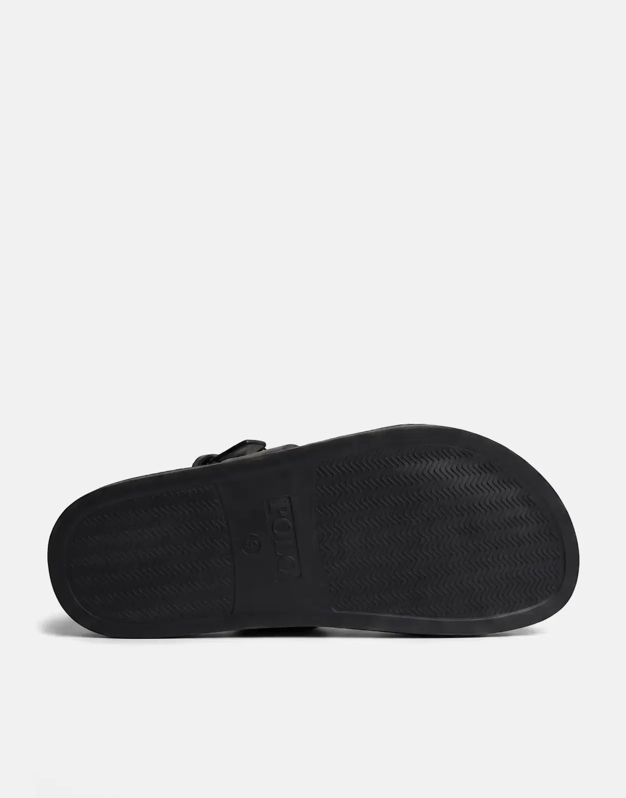 Black Polo Moulded New Trim slide sandal, showcasing the bottom of the sole with a textured grip pattern and branding.