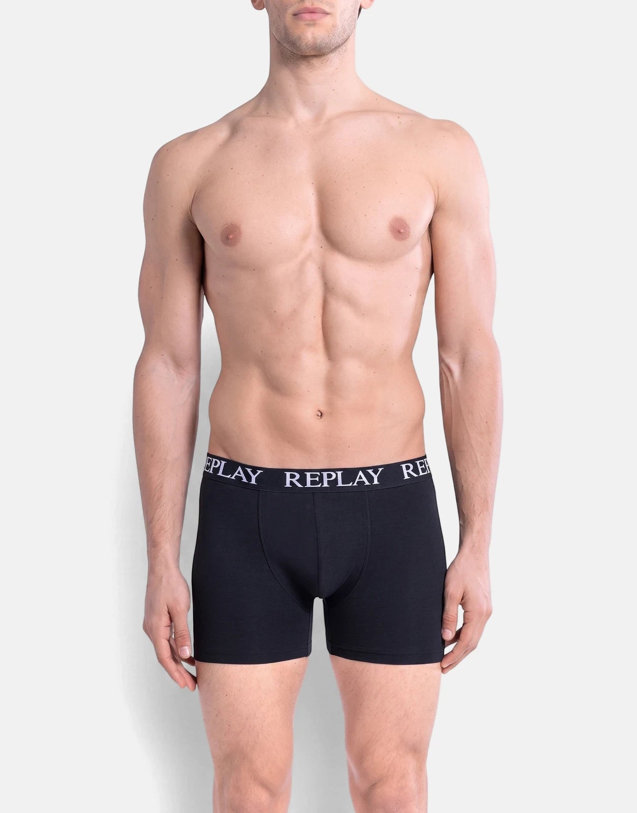 Male model wearing black Replay boxer briefs from the 3 pack underwear set, showcasing the brand logo and fit.