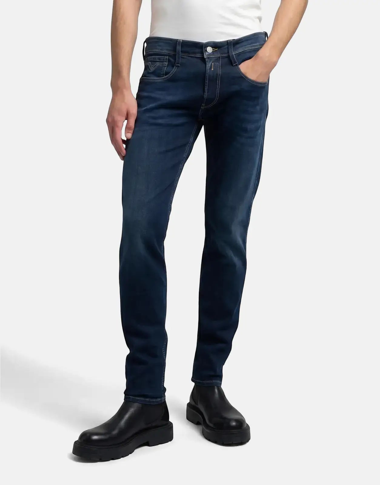 Men's Replay Back Label Anbass Dark Blue Jeans, worn by a model from the torso down, paired with black boots, on a neutral
