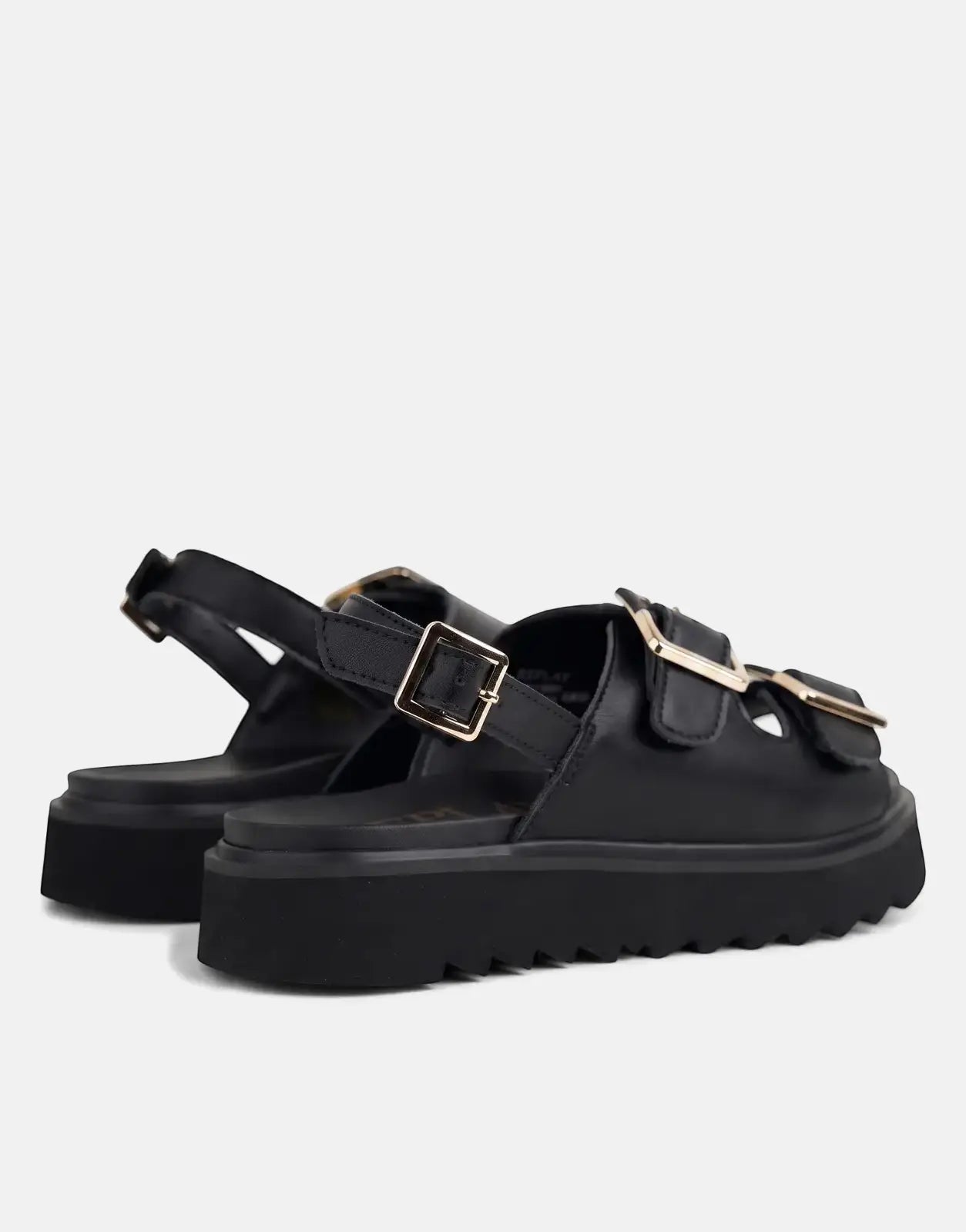 Close-up of a pair of Replay New Alicante black platform sandals with gold buckles, angled view.