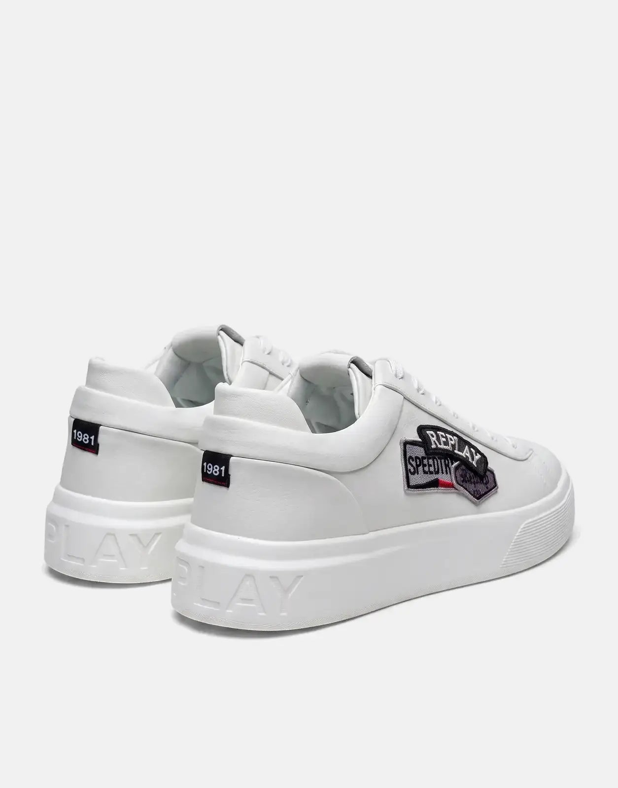 A pair of white Replay Notting Badges sneakers are shown from a rear-quarter view, highlighting the side patches and thick