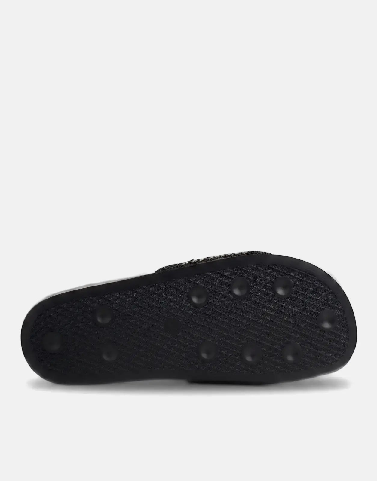 Bottom view of a black Replay Up Trap slide sandal showing the textured sole with circular grip details.