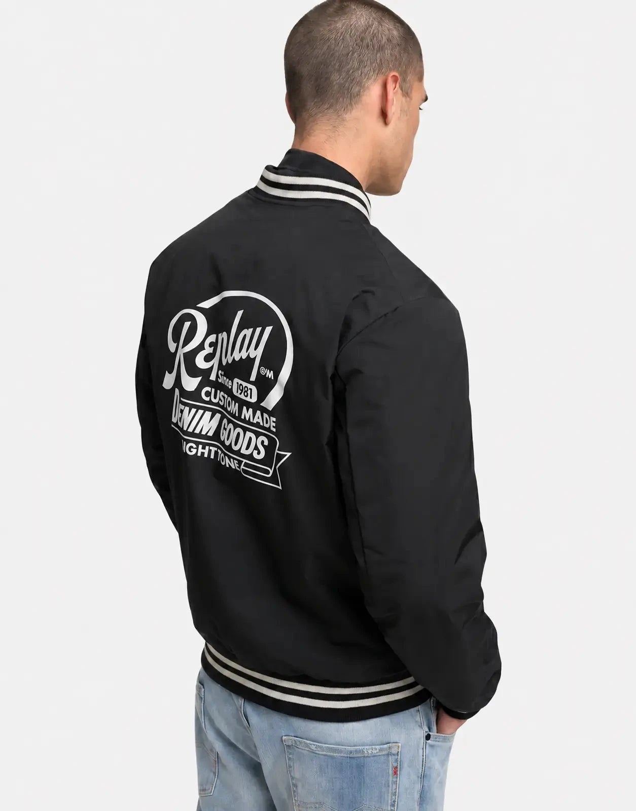 Replay Varsity Black Jacket, back view with large logo print and striped rib collar and hem.