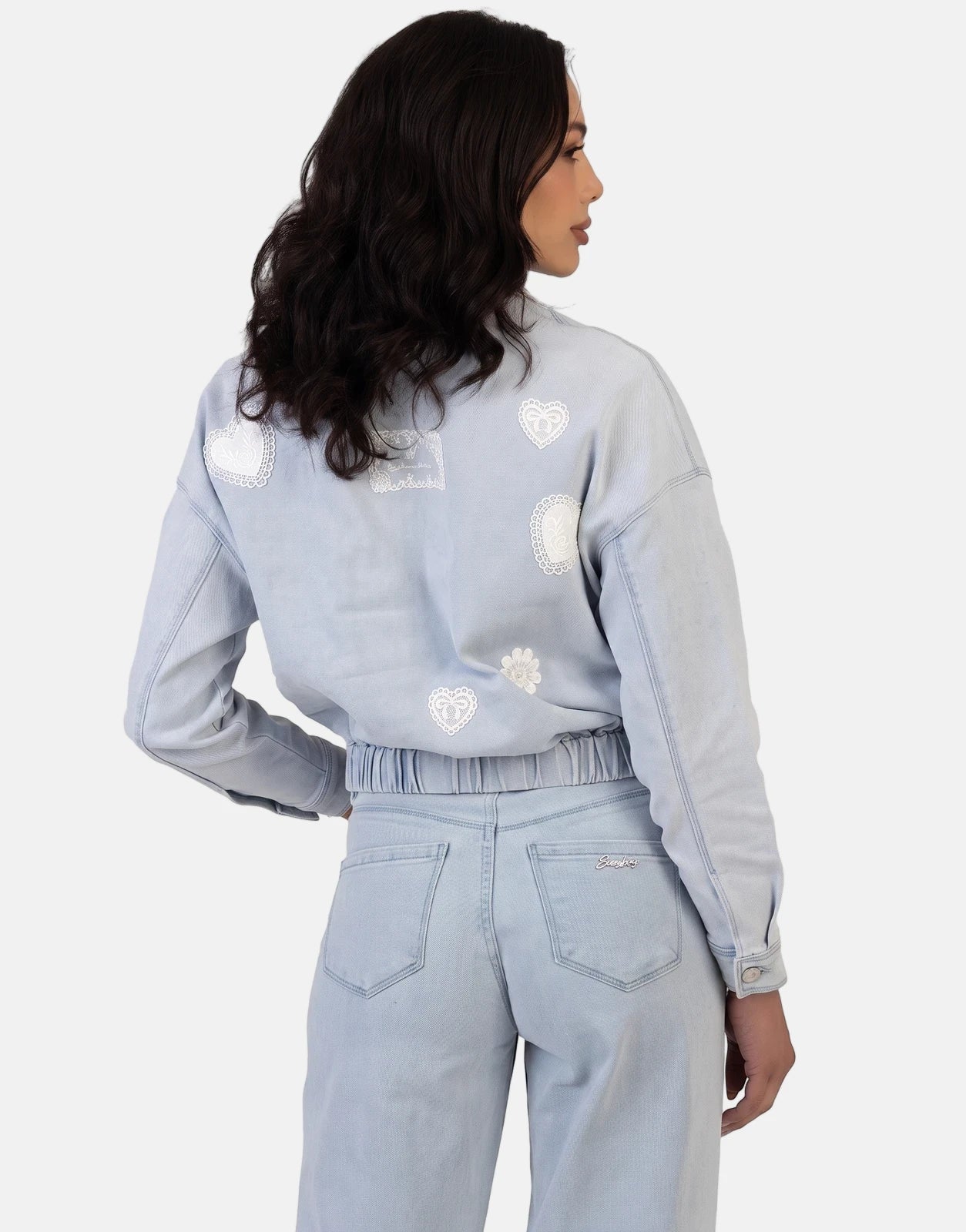 Sissy Boy Kiera Light Vintage Denim Bomber Jacket with lace heart patches and matching jeans, worn by a female model seen