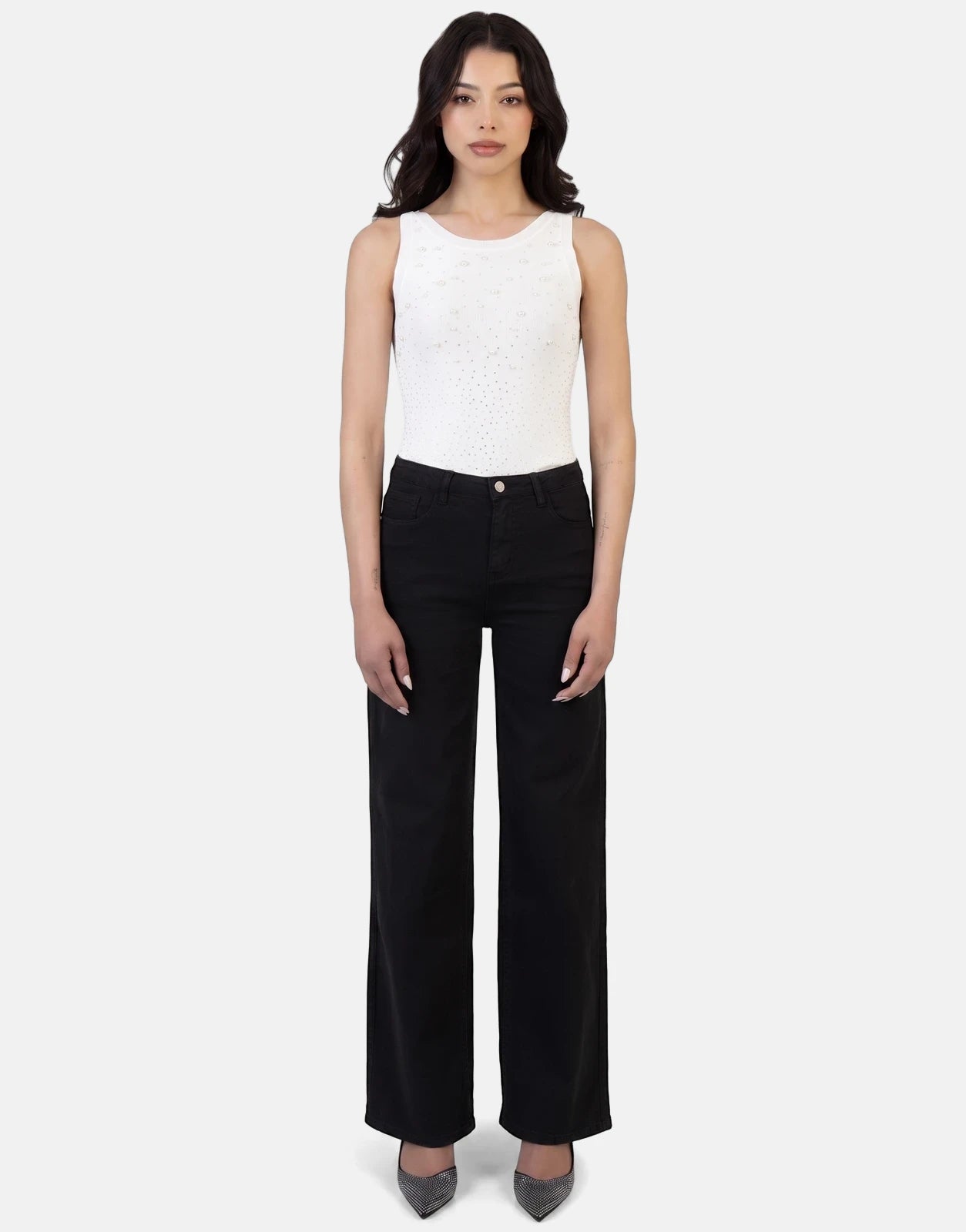 Full body shot of a woman wearing a white pearl-embellished sleeveless top, Sissy Boy Nollene wide leg black high waist