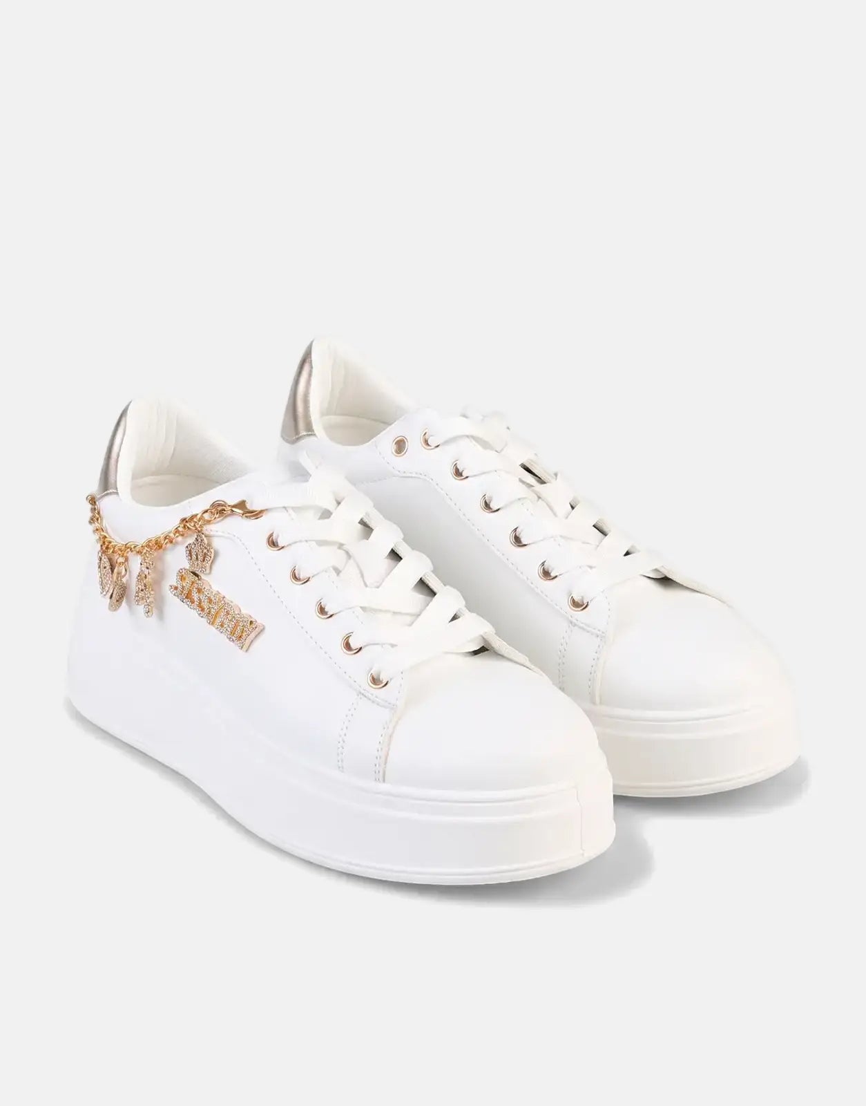 Pair of Sissy Boy Tatum low-top sneakers in white with gold accents, featuring rhinestone 'SISSY BOY' and charm details.