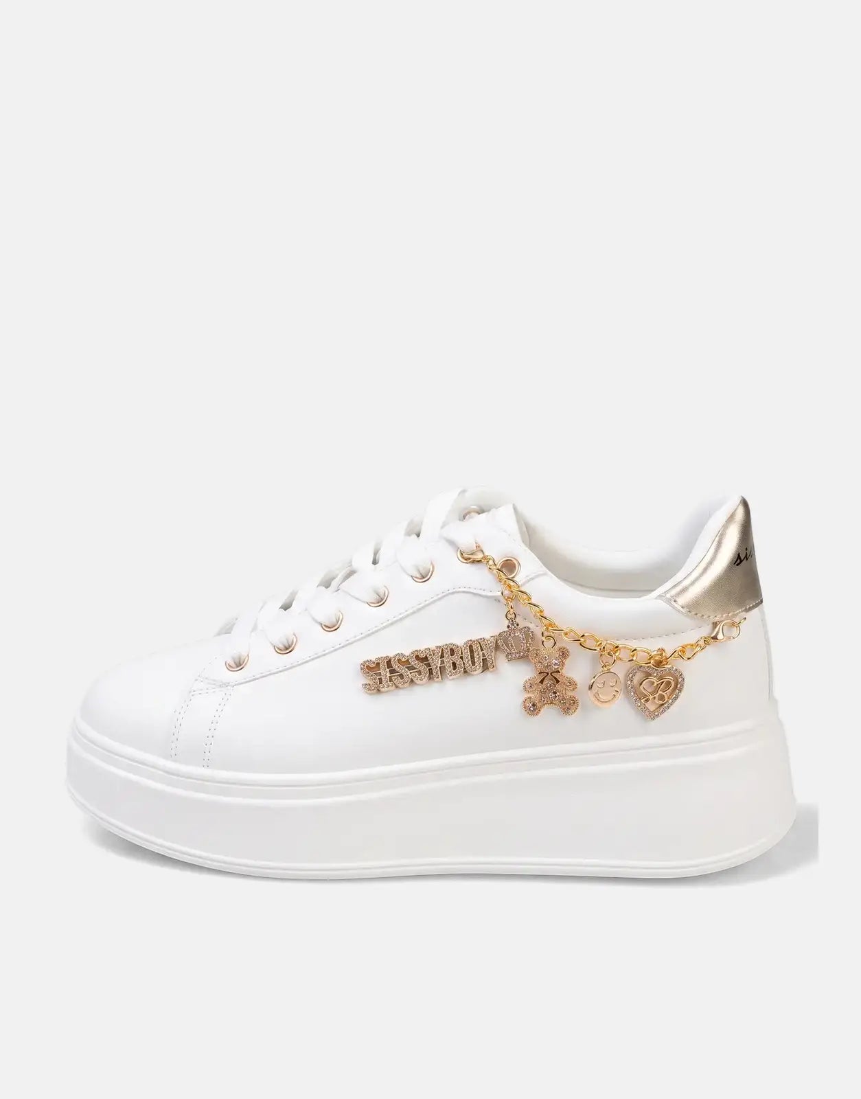 Sissy Boy Tatum white and gold platform sneakers with rhinestone-studded text and a decorative charm chain on a white