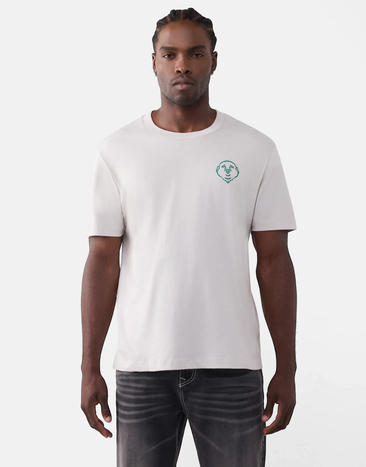 Male model wearing a light grey True Religion Abstract Denim T-shirt with a green Buddha logo and dark wash jeans.