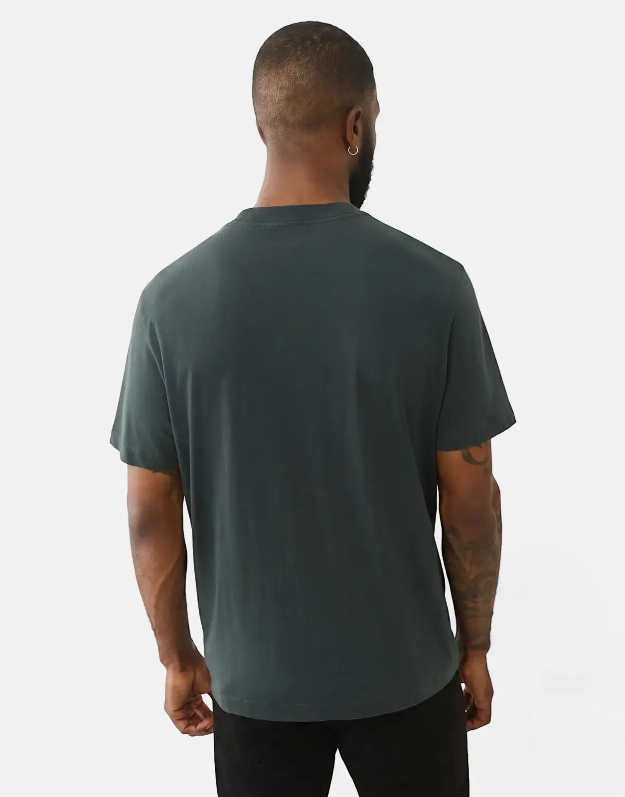A male model from behind wearing a dark green True Religion Buddha Arch Logo T-Shirt, showcasing the back and short sleeves.