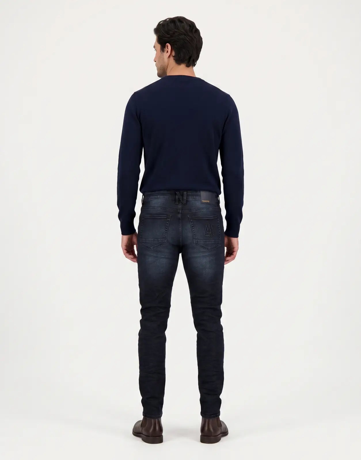 Back view of TSHEPO Takalani C1 Mid Indigo Jeans, featuring dark blue washed denim with classic five-pocket styling.