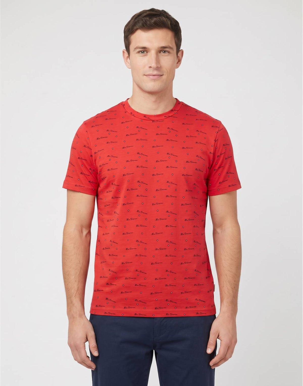 Front view of a Ben Sherman Tar Aop Red T-Shirt for men, featuring an all-over black script logo print and a classic crew
