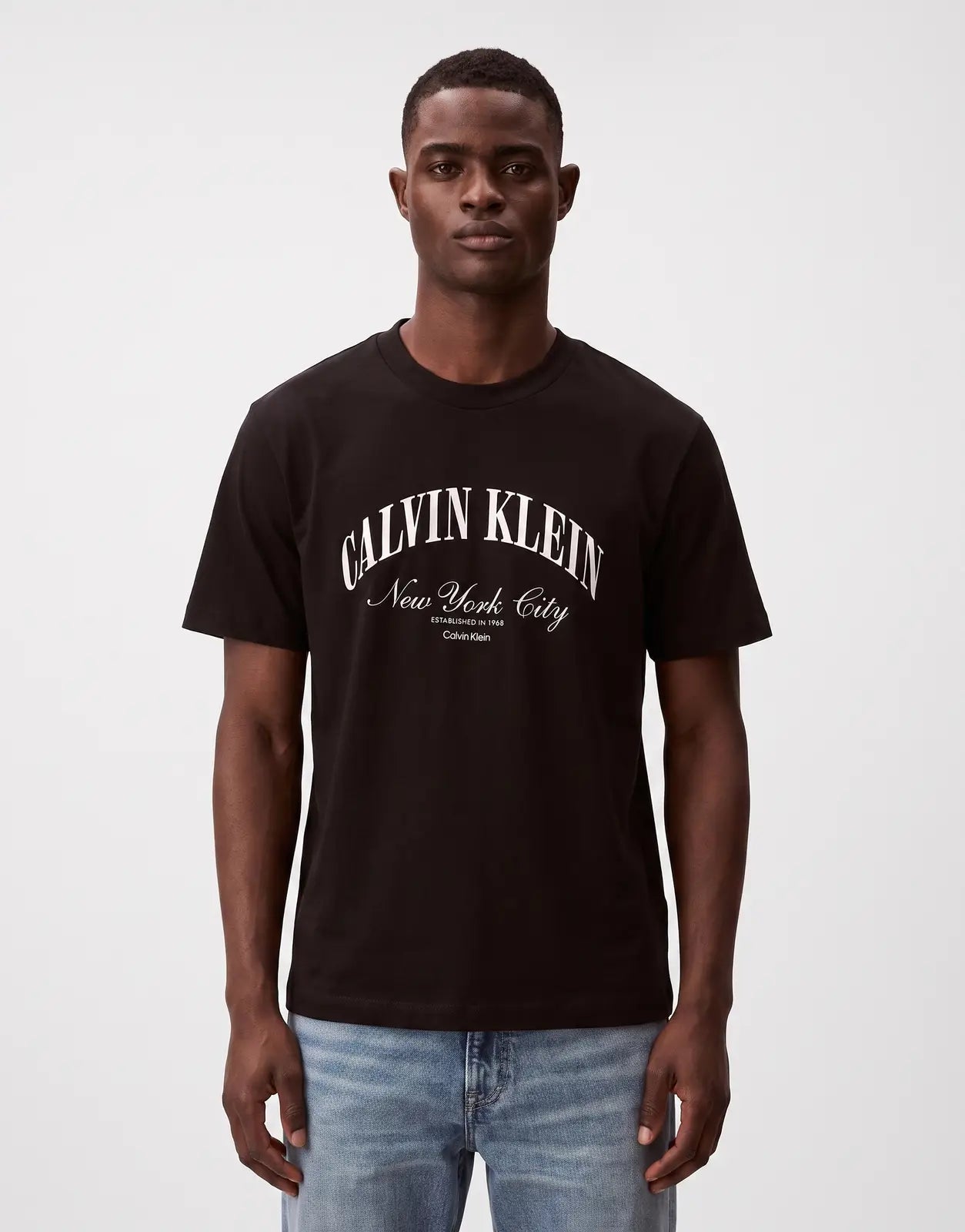 Front view of a Calvin Klein 20s March Graphic Seasonal Fashion black t-shirt with white 'New York City' logo, worn by a