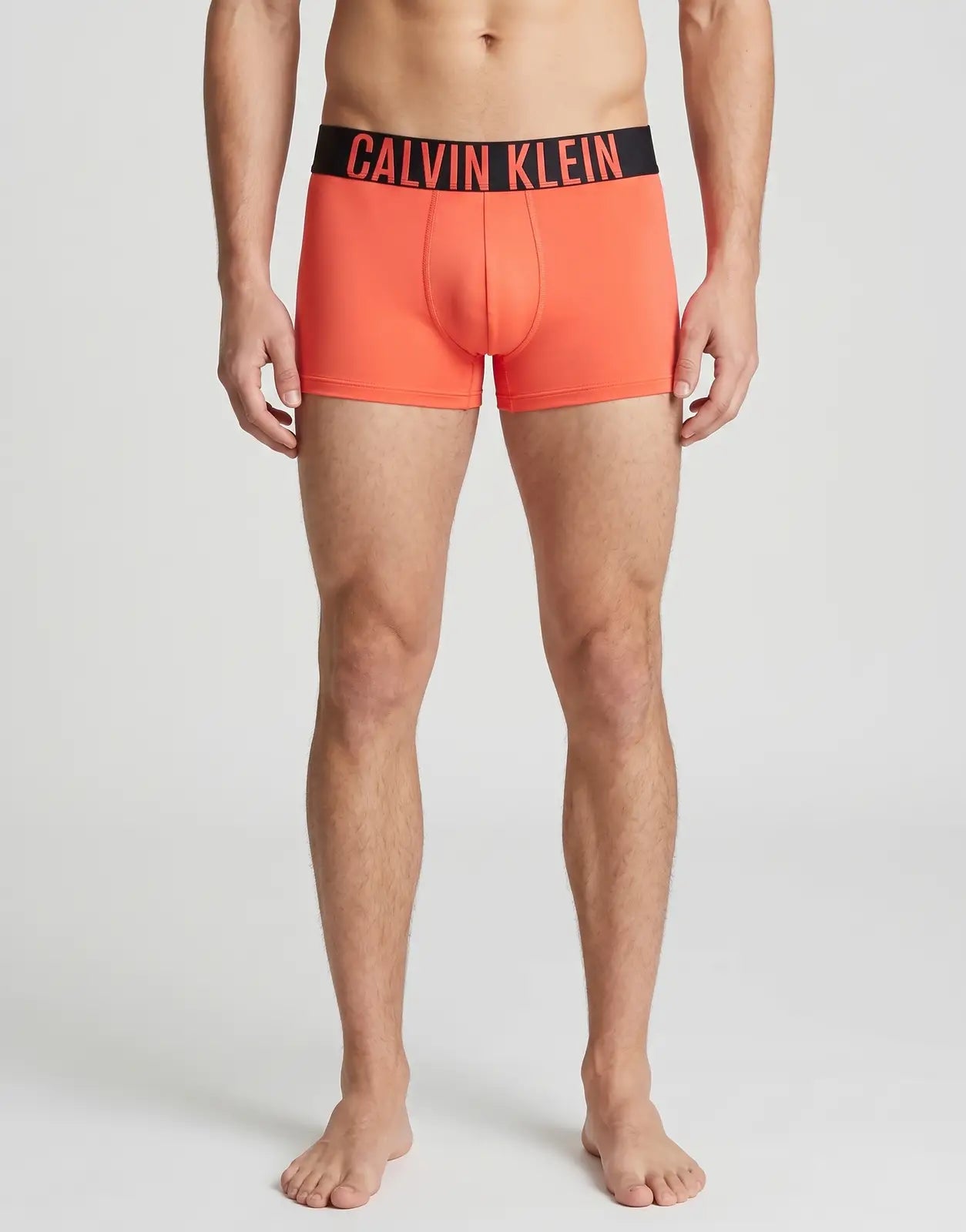 Calvin Klein 3 Pack Trunk Multi, orange trunk with black logo waistband shown from the front on model.