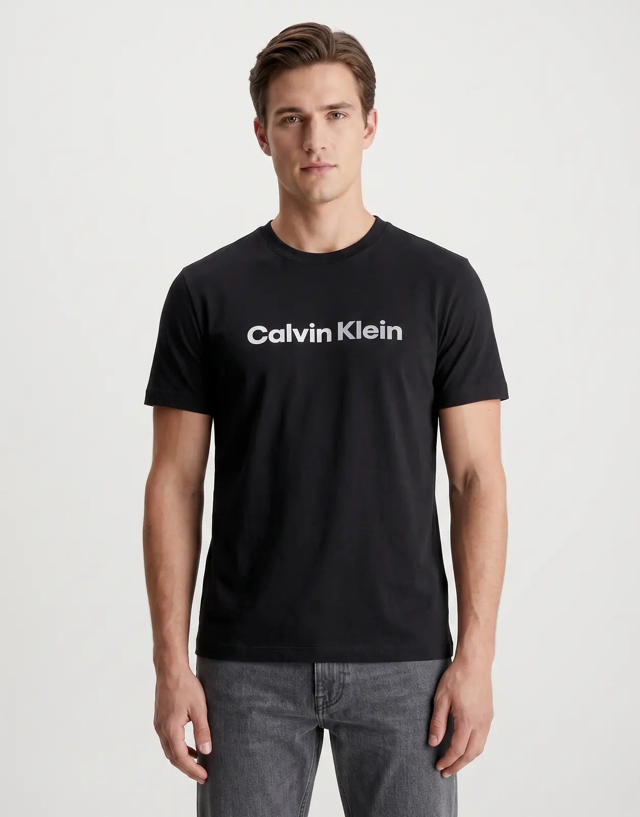A black Calvin Klein 30s Graphic T-Shirt, featuring a prominent logo on the chest. This short-sleeve cotton tee offers a