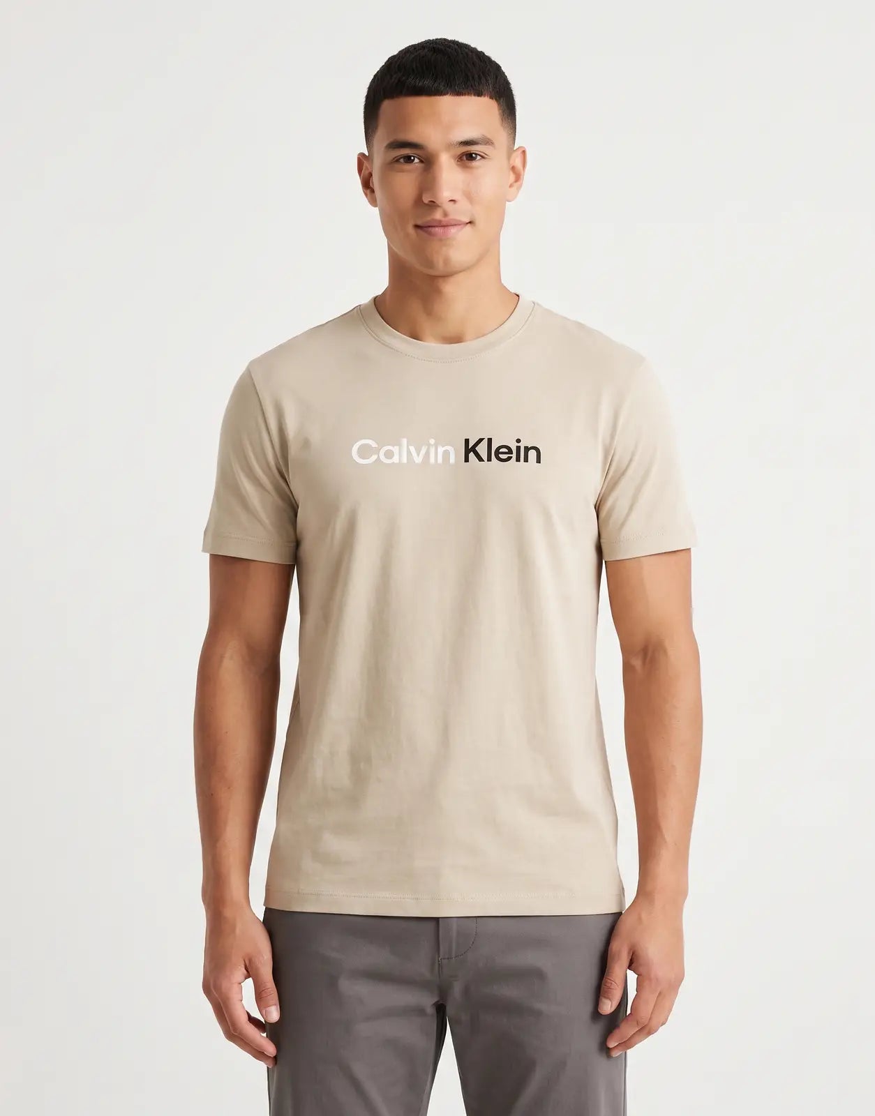 A beige Calvin Klein 30s Wholesale Jeans graphic T-shirt, made from soft cotton, displayed flat, front view.