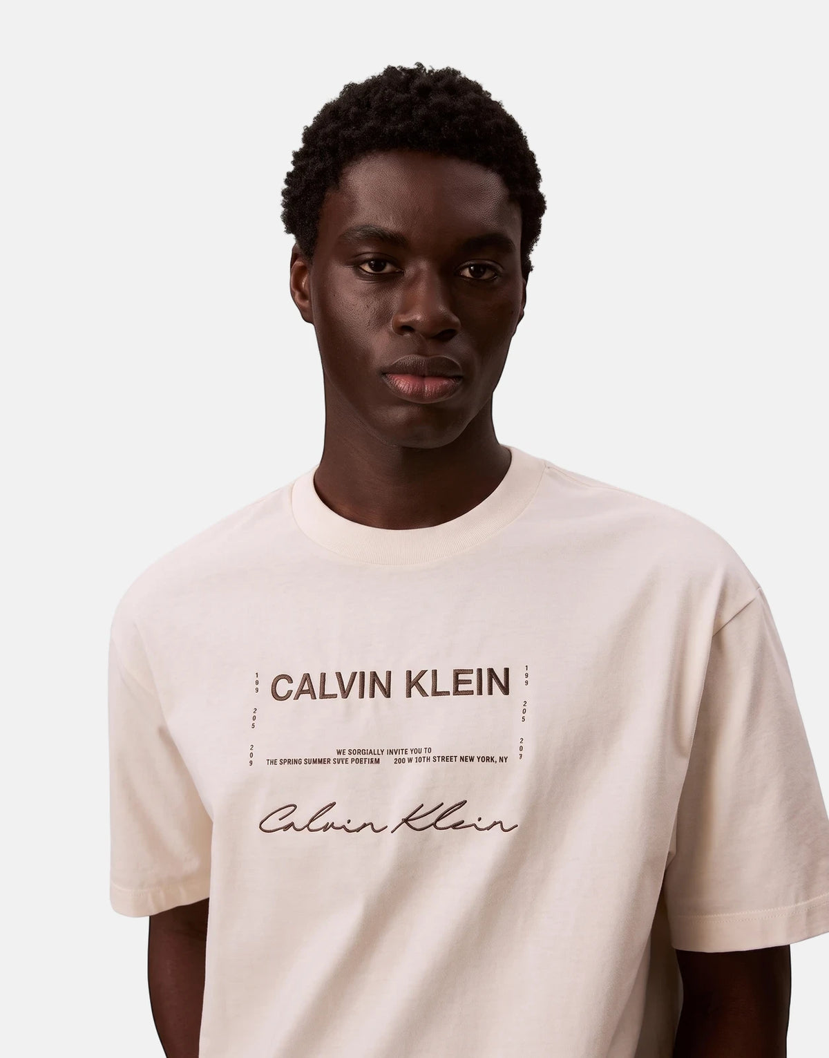 Calvin Klein 16s April Graphic Seasonal Fashion white short-sleeve t-shirt worn by a male model, front view.
