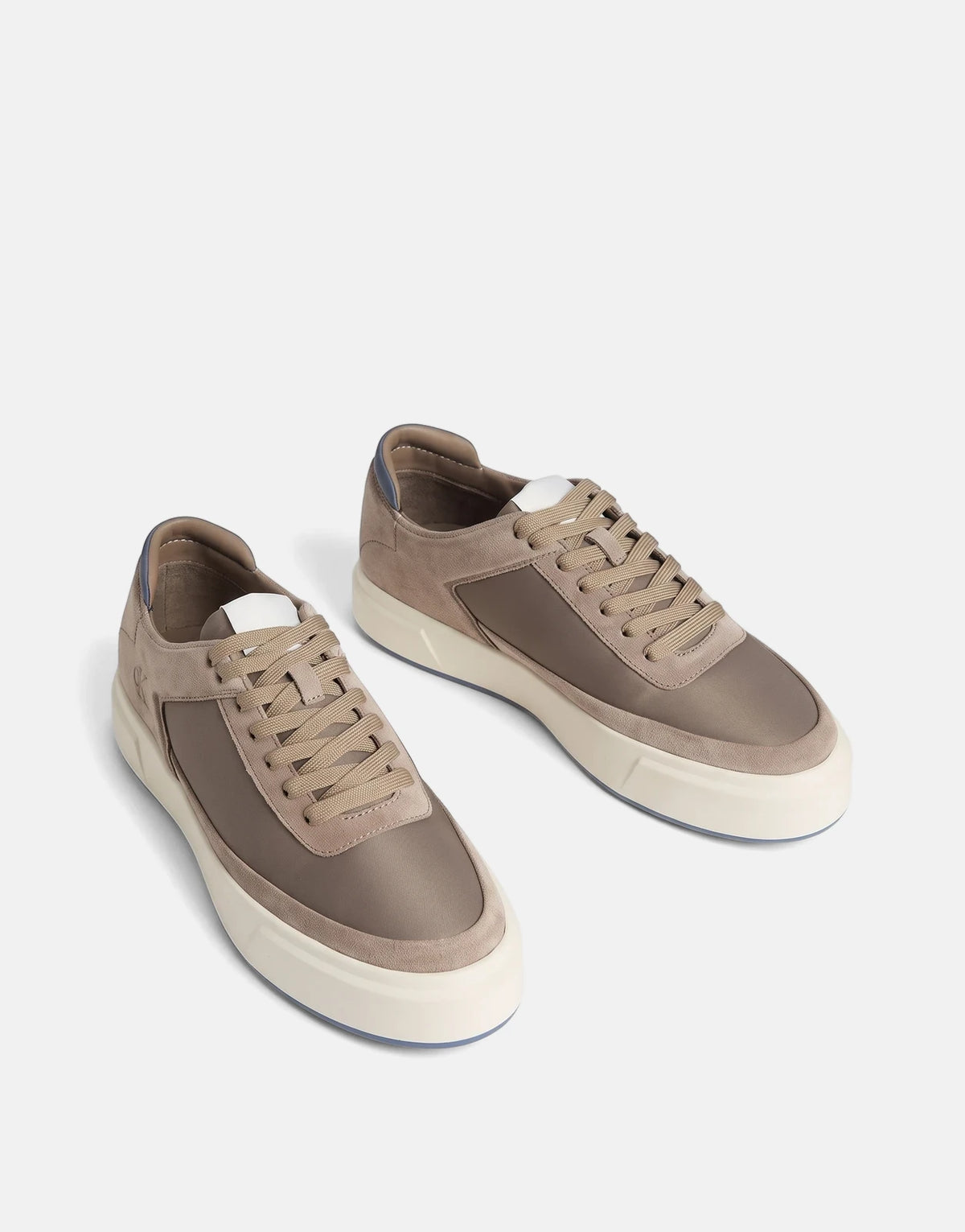 A pair of Calvin Klein Basket Cupsole Laceup Multi Sneakers in tan suede and brown textile with white soles, angled view.