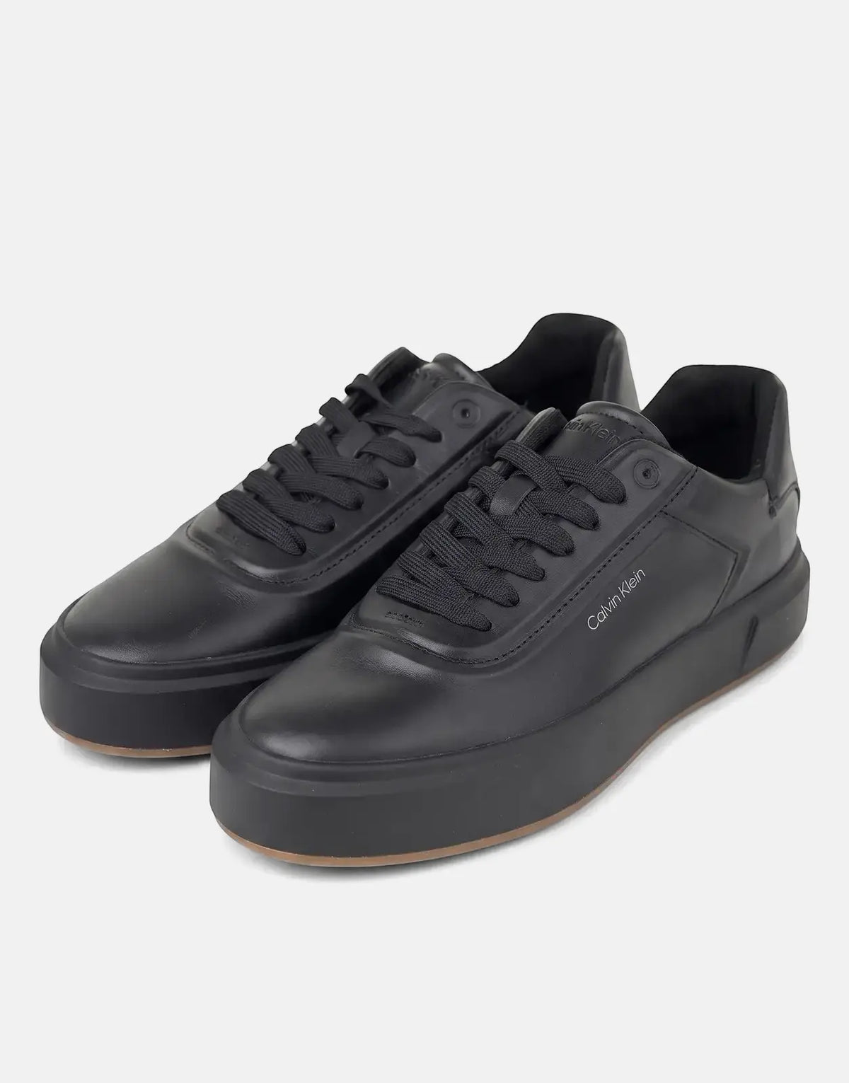 Pair of black Calvin Klein Basket Cupsole Oxford Laceup leather sneakers, angled view on a white background.