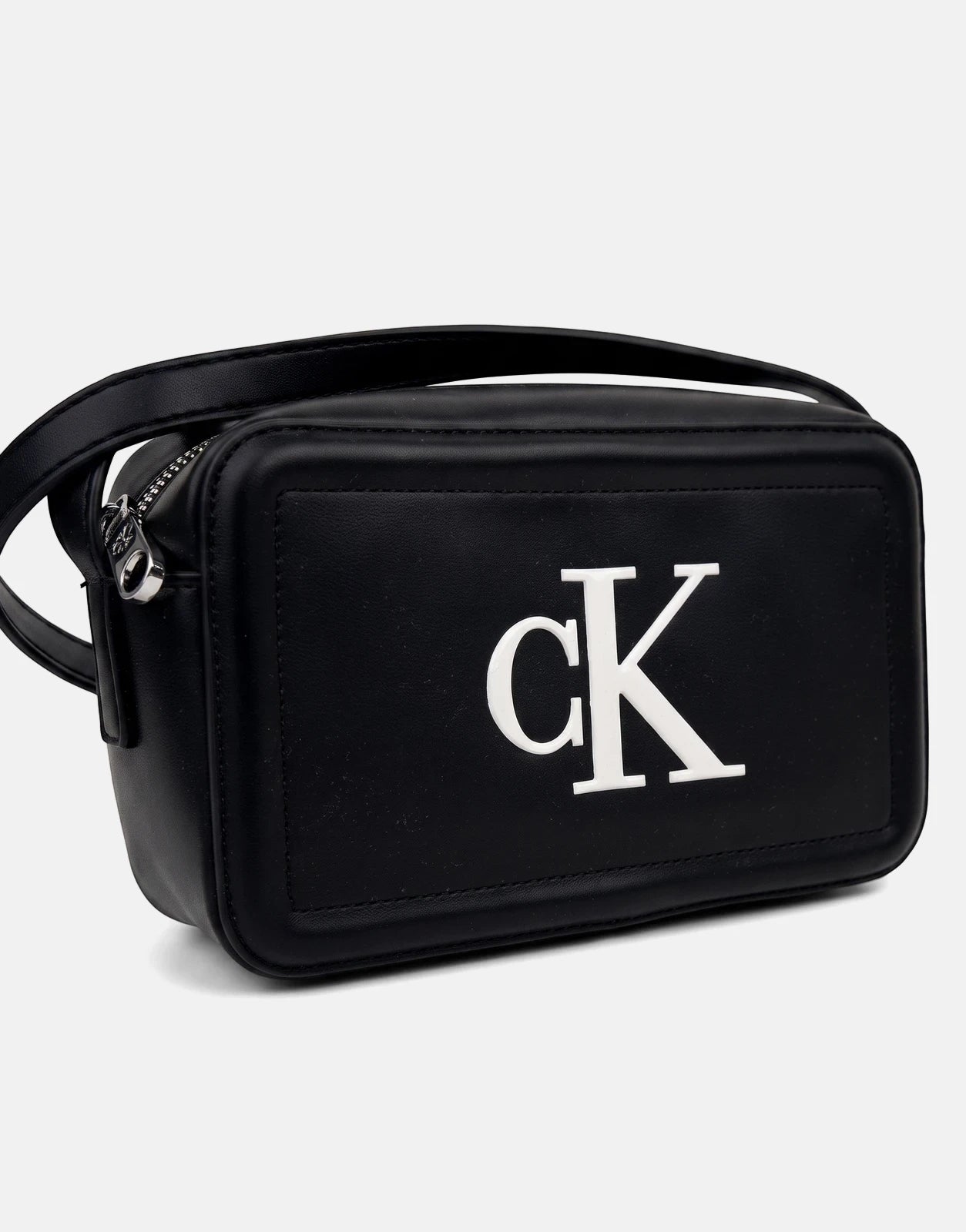 Black Calvin Klein Bold CK camera bag with white logo and silver zipper hardware, shown from an angled front view.