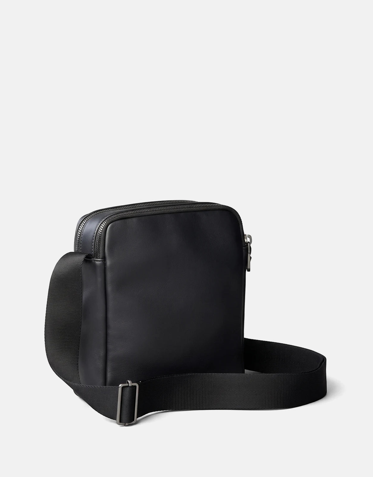 Calvin Klein Bold CK Pocket Reporter black bag made of smooth leather with two top zippers and an adjustable fabric strap.