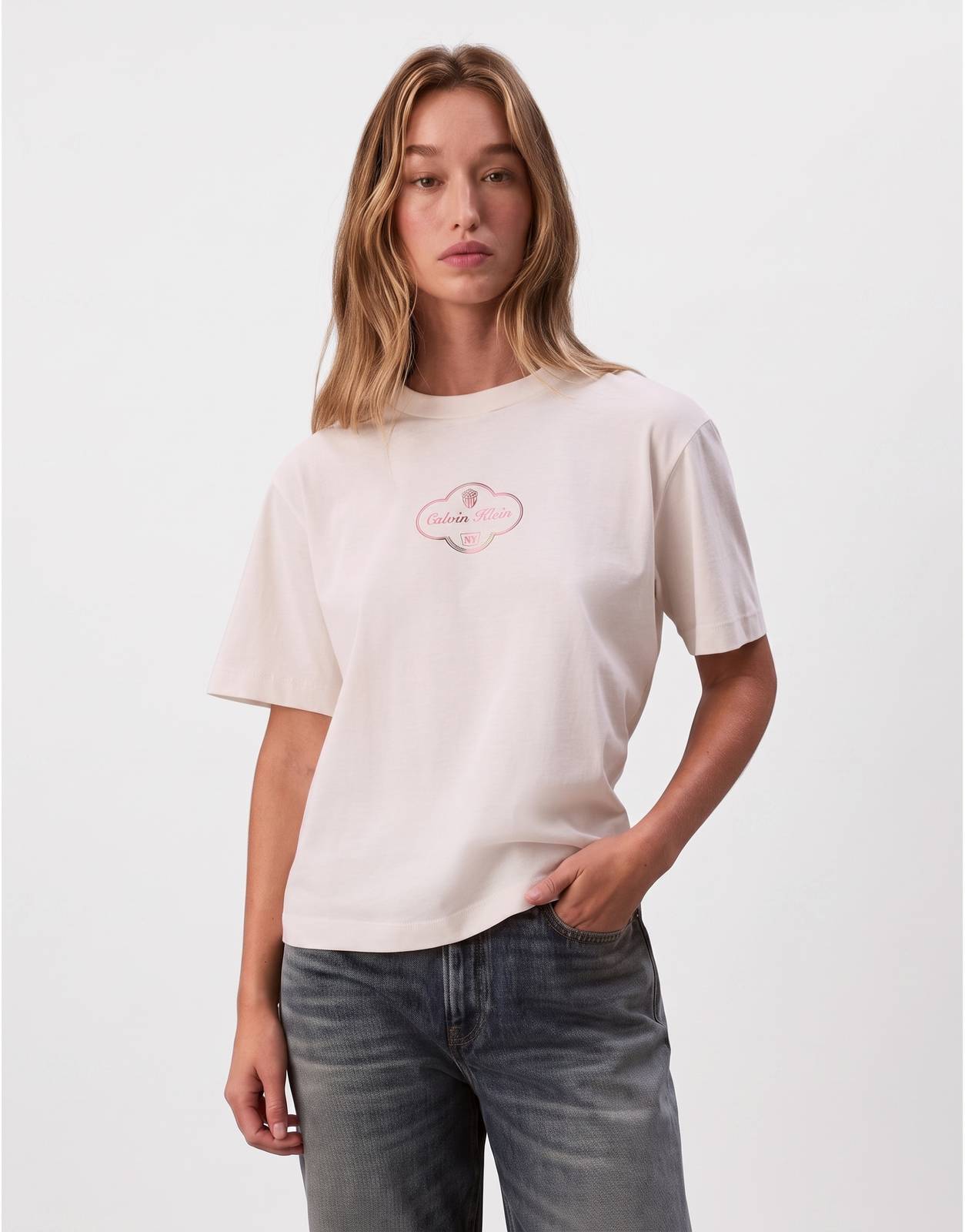 Women's Calvin Klein Boxy Cocktail Logo T-Shirt in cream/off-white, with a metallic pink and gold cloud-shaped logo. Short