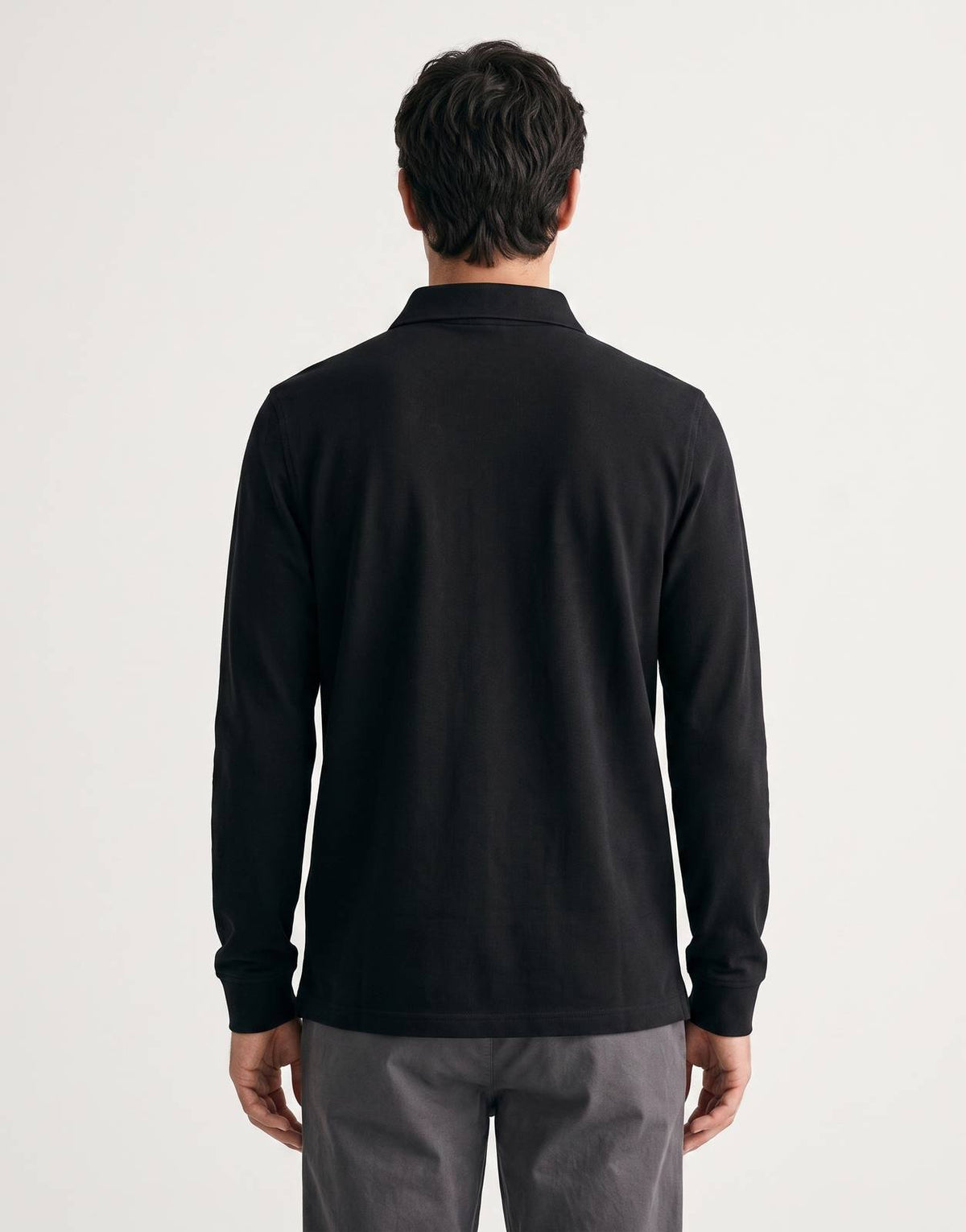 Back view of a Calvin Klein casual pique polo shirt in black, featuring long sleeves and a collared neckline.