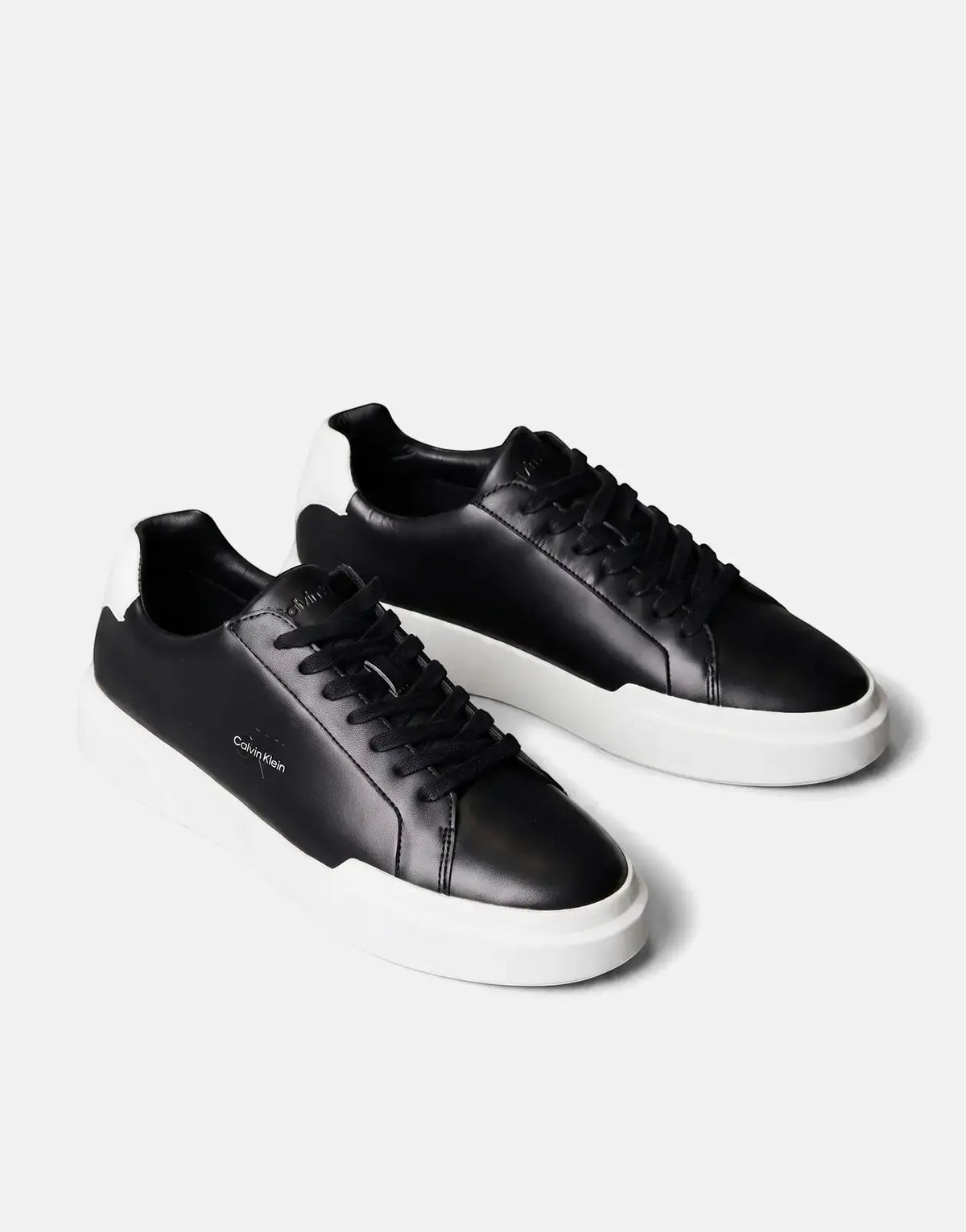Calvin Klein Chunky Cupsole sneakers, crafted from black and white leather, presented in an angled studio shot.