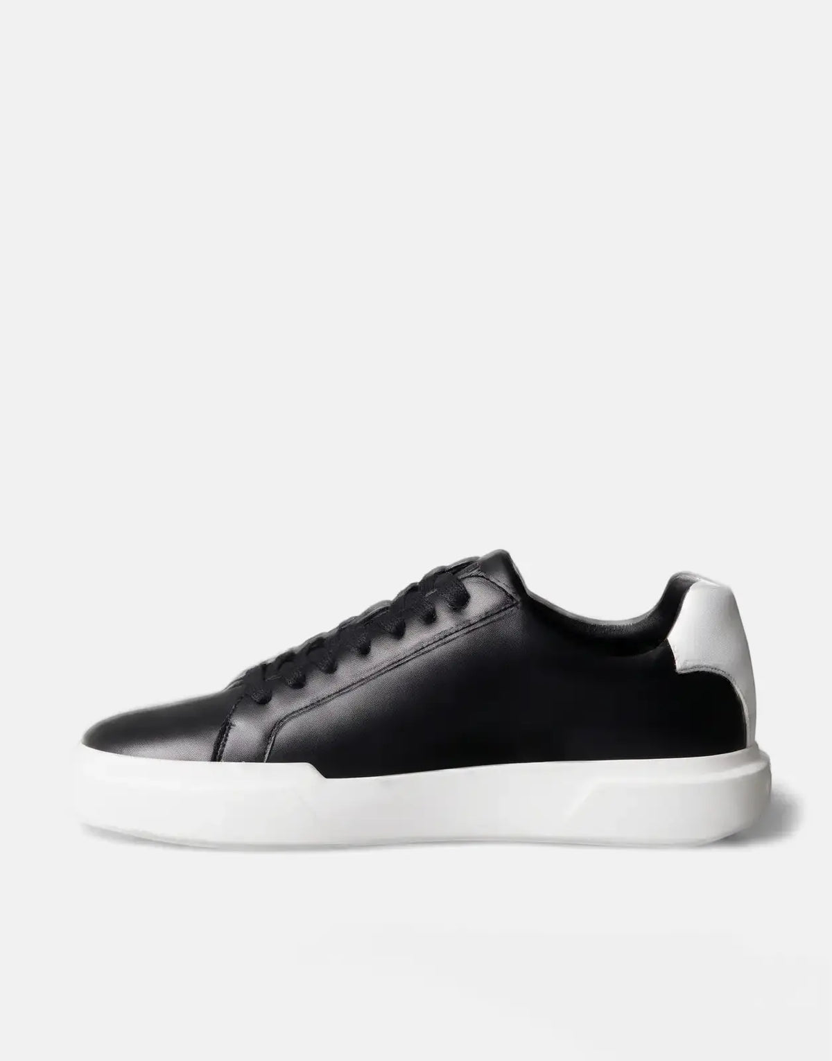 Calvin Klein Chunky Cupsole Sneaker in black leather with a thick white sole and white heel accent, side view.