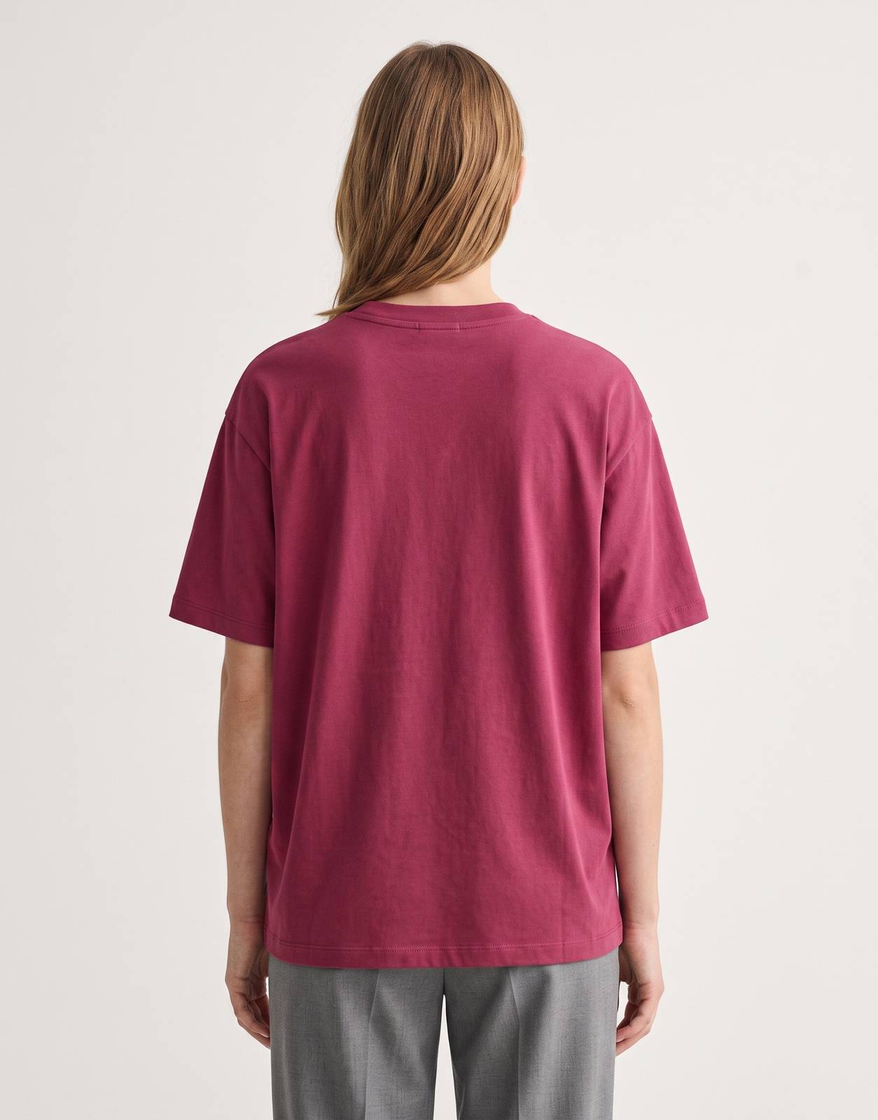 Back view of a women's Calvin Klein CK NY Oversized Berry T-Shirt, featuring a relaxed fit, short sleeves, and a simple crew