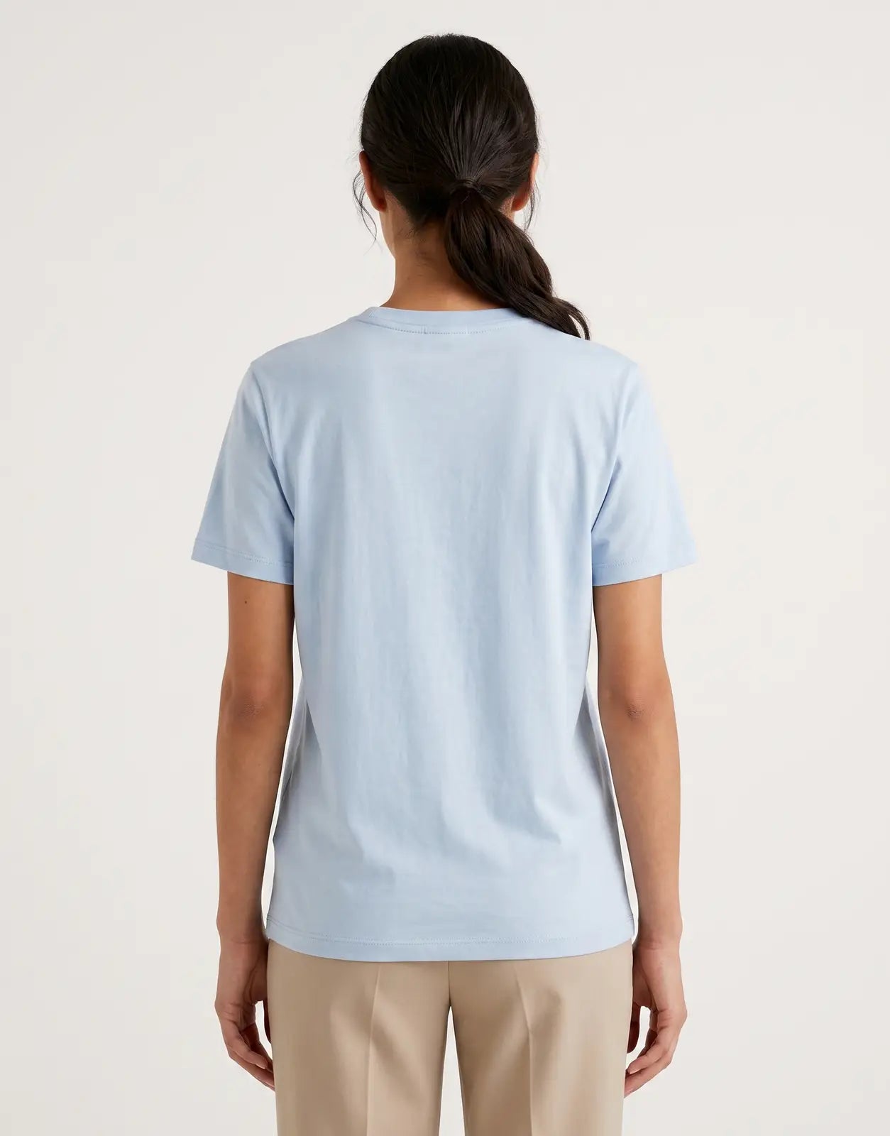 Light blue Calvin Klein Classic Fit T-Shirt laid flat, viewed from the back, showcasing its smooth fabric and simple design.