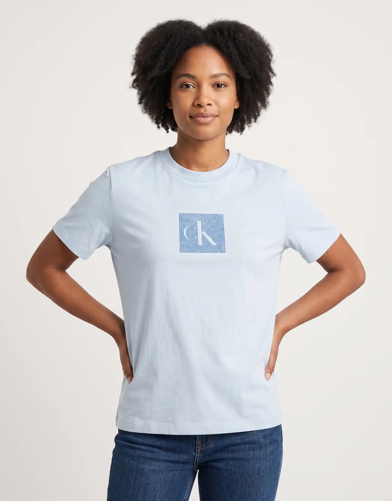 Light blue Calvin Klein Classic Fit T-shirt featuring a subtle blue monogram logo on the chest, crafted from soft cotton.