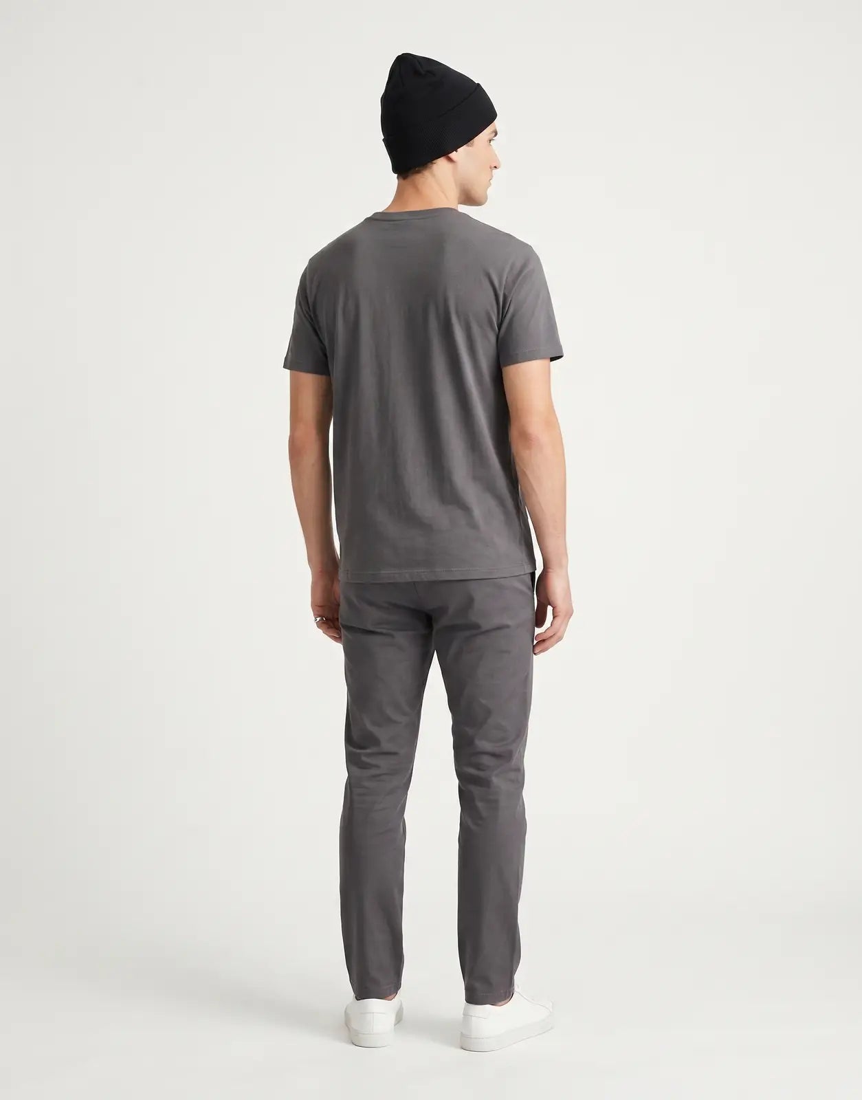 A black Calvin Klein Fine Rib Beanie, shown from the back, highlighting its soft, fine-ribbed knit texture and classic fit.
