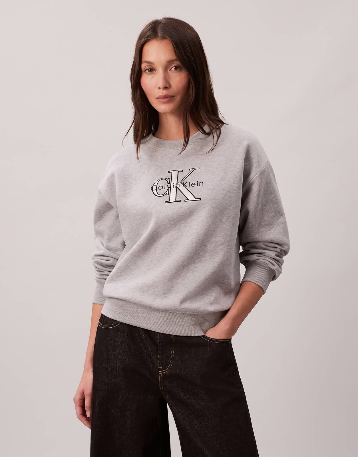 Calvin Klein Foil Monologo French Terry Relaxed Grey Sweatshirt on a model, showcasing its soft fabric and prominent logo.