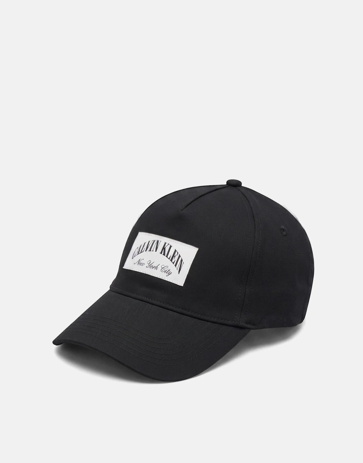 Black Calvin Klein Heritage Crest baseball cap with a white 'New York City' logo patch on the front, offering a casual and