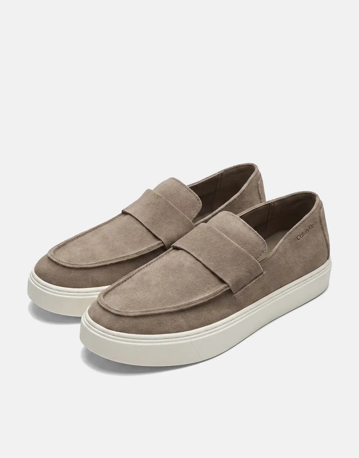 Pair of Calvin Klein Hybrid Clean Cup taupe suede loafers with white platform soles, shown from an elevated side view.