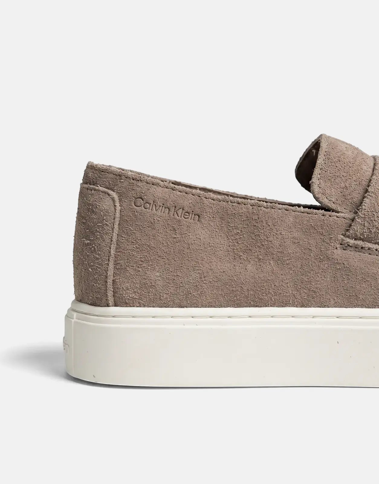 Close-up of a single Calvin Klein Hybrid Clean Cup loafer in taupe suede, featuring a clean white sole.