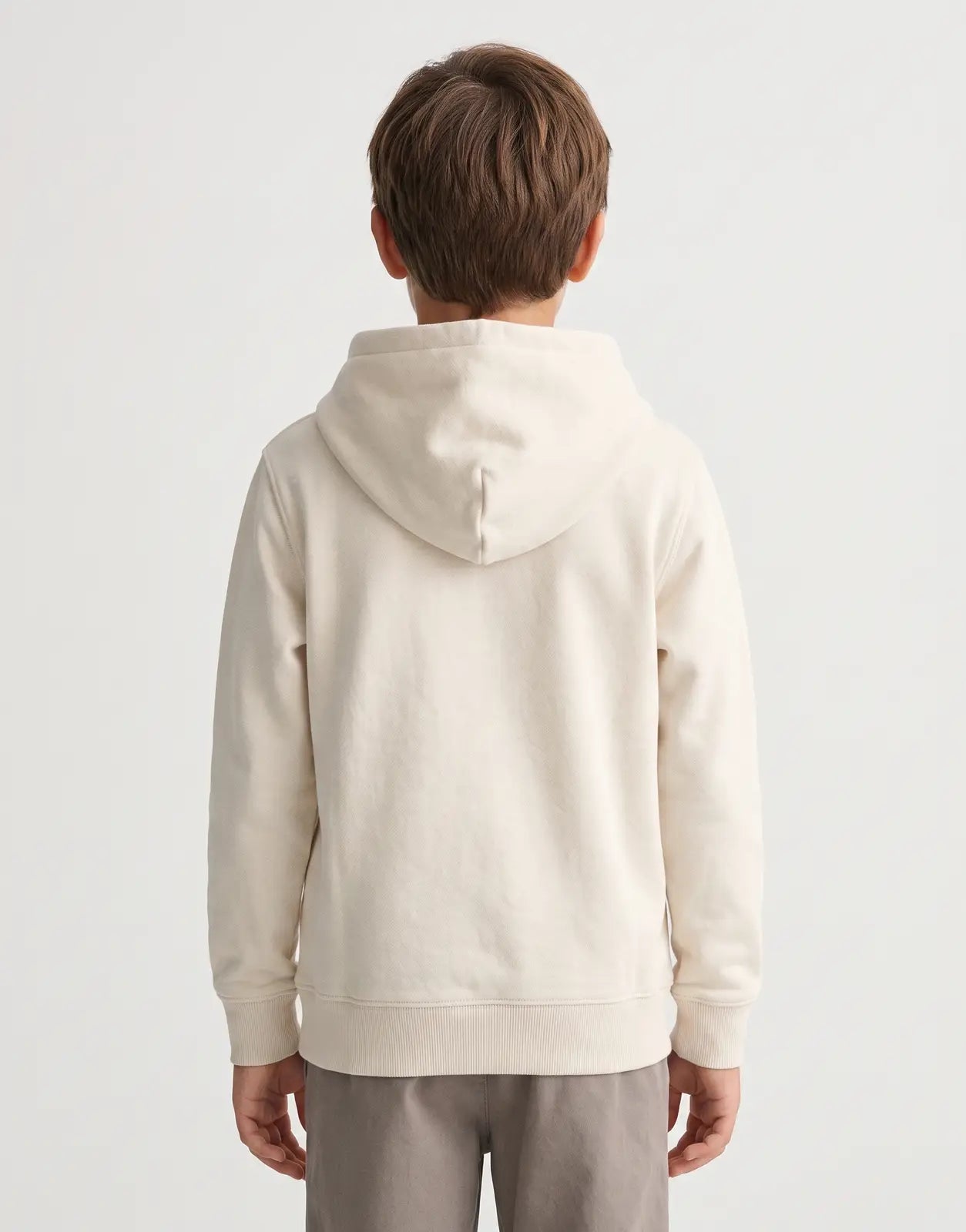 Back view of a child model wearing a Calvin Klein Kids Inst Logo Terry Beige Hoodie made from soft terry fabric, showcasing