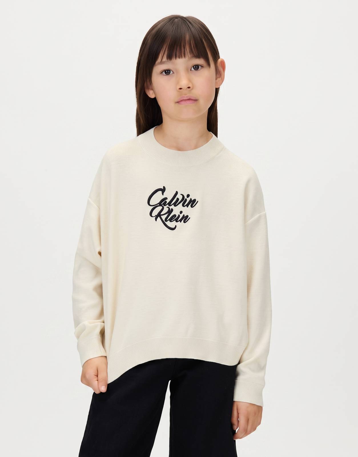 Calvin Klein Kids Script Logo Sweatshirt in cream, front view. A soft knit long-sleeve top for children with black script