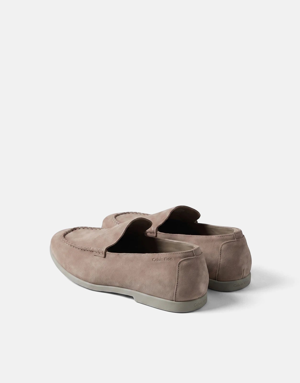 A pair of Calvin Klein Low Prof taupe suede loafers, showcasing the design and textured material.