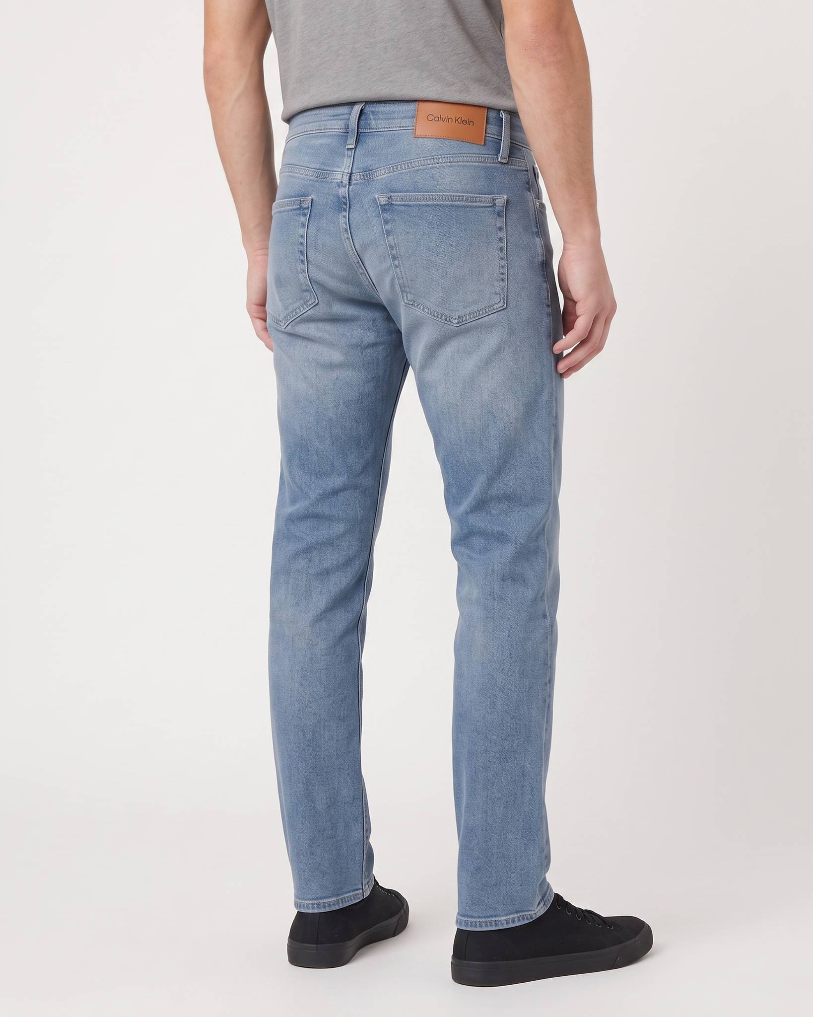Back view of men's Calvin Klein Slim Faded Clearwater Denim Medium Jeans, highlighting the comfortable slim fit and light
