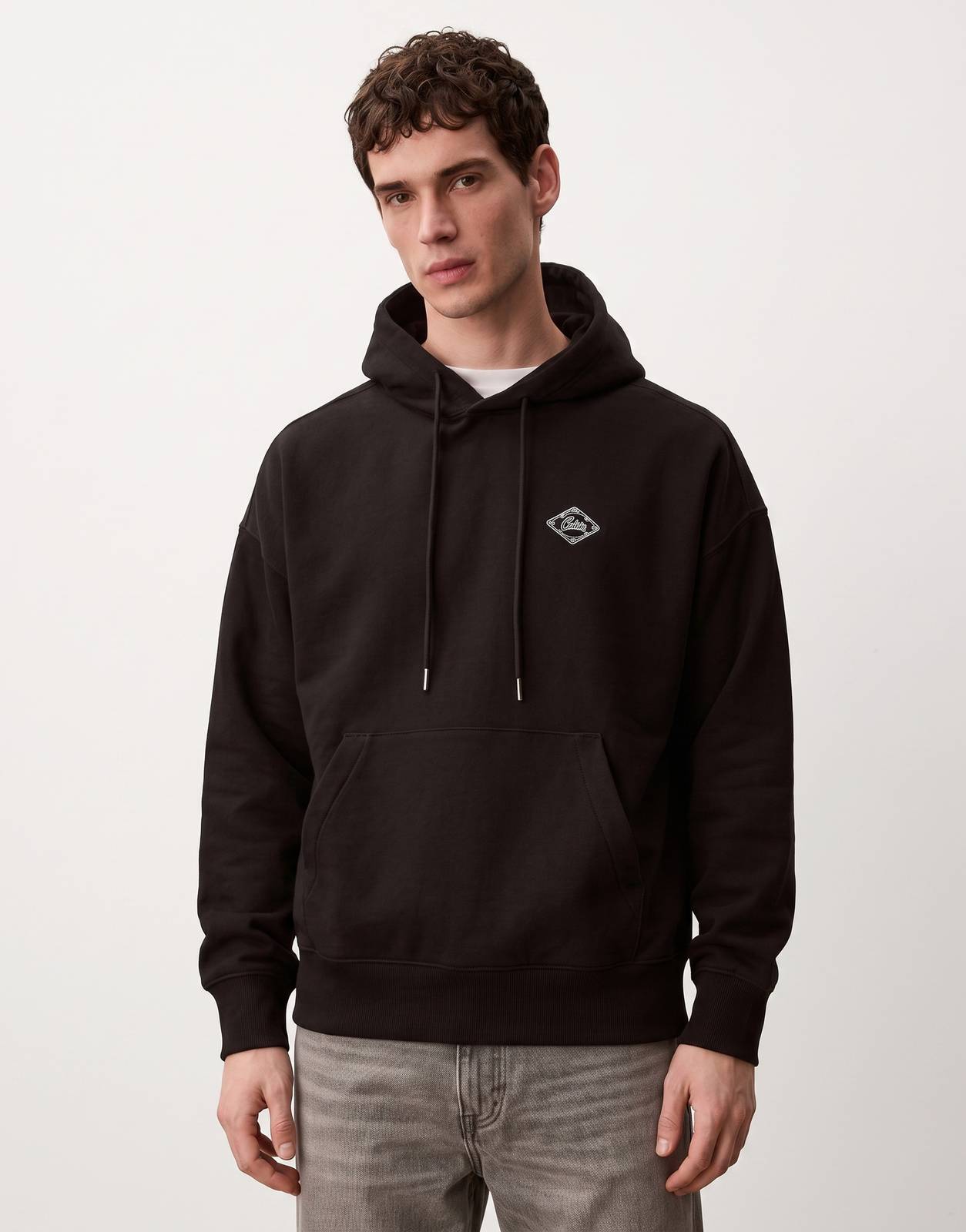 Calvin Klein Premium Fleece Matchbox Black Hoodie for men, featuring a relaxed fit, drawstring hood, and front kangaroo