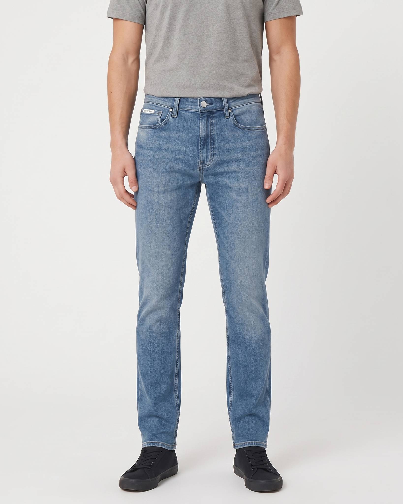 Calvin Klein Slim Faded Clearwater Denim Medium Jeans, front view, in a medium blue wash with distressed detailing.