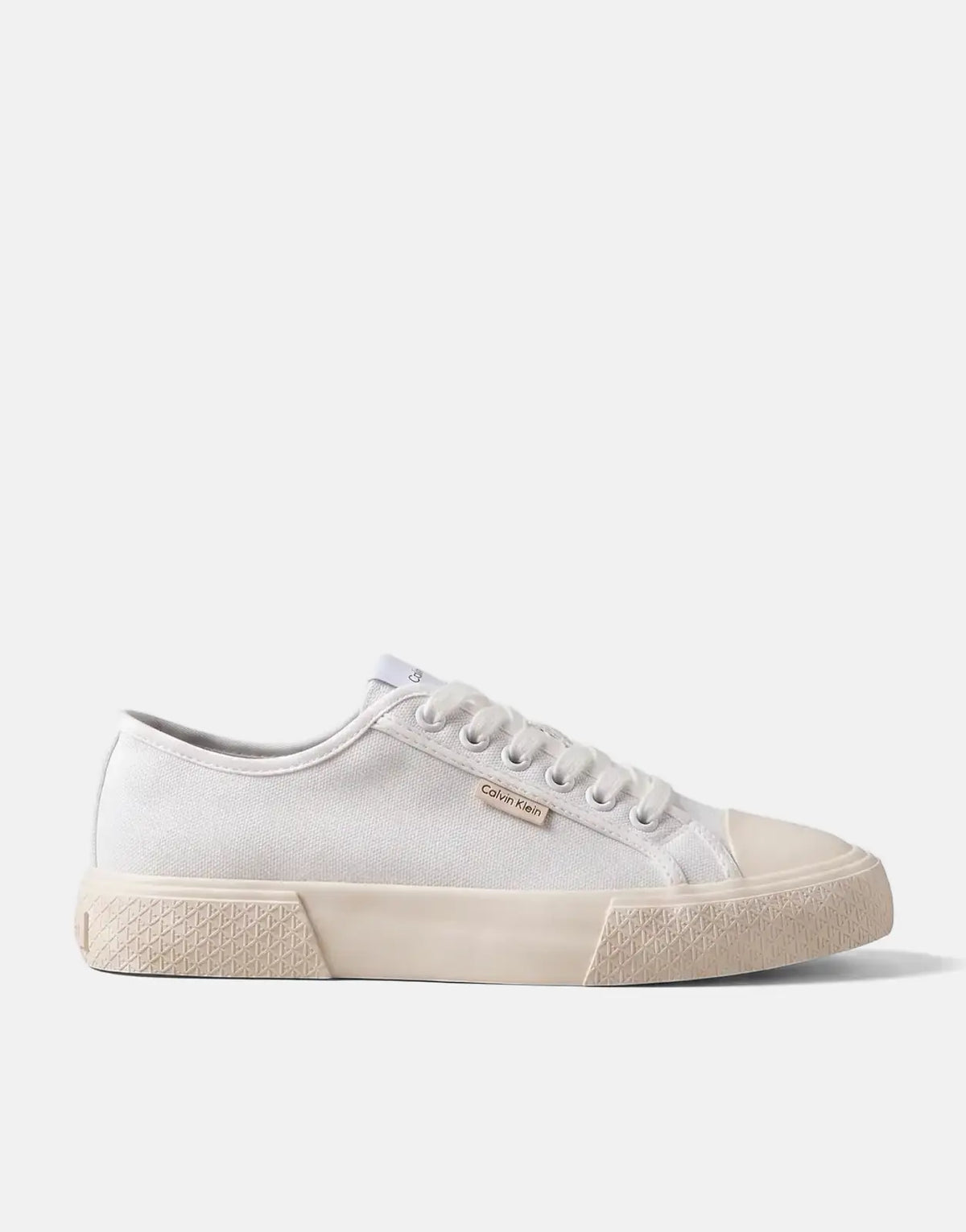 Calvin Klein Vulc Low Laceup White Canvas sneaker, shown from a side view, featuring white laces and an off-white textured