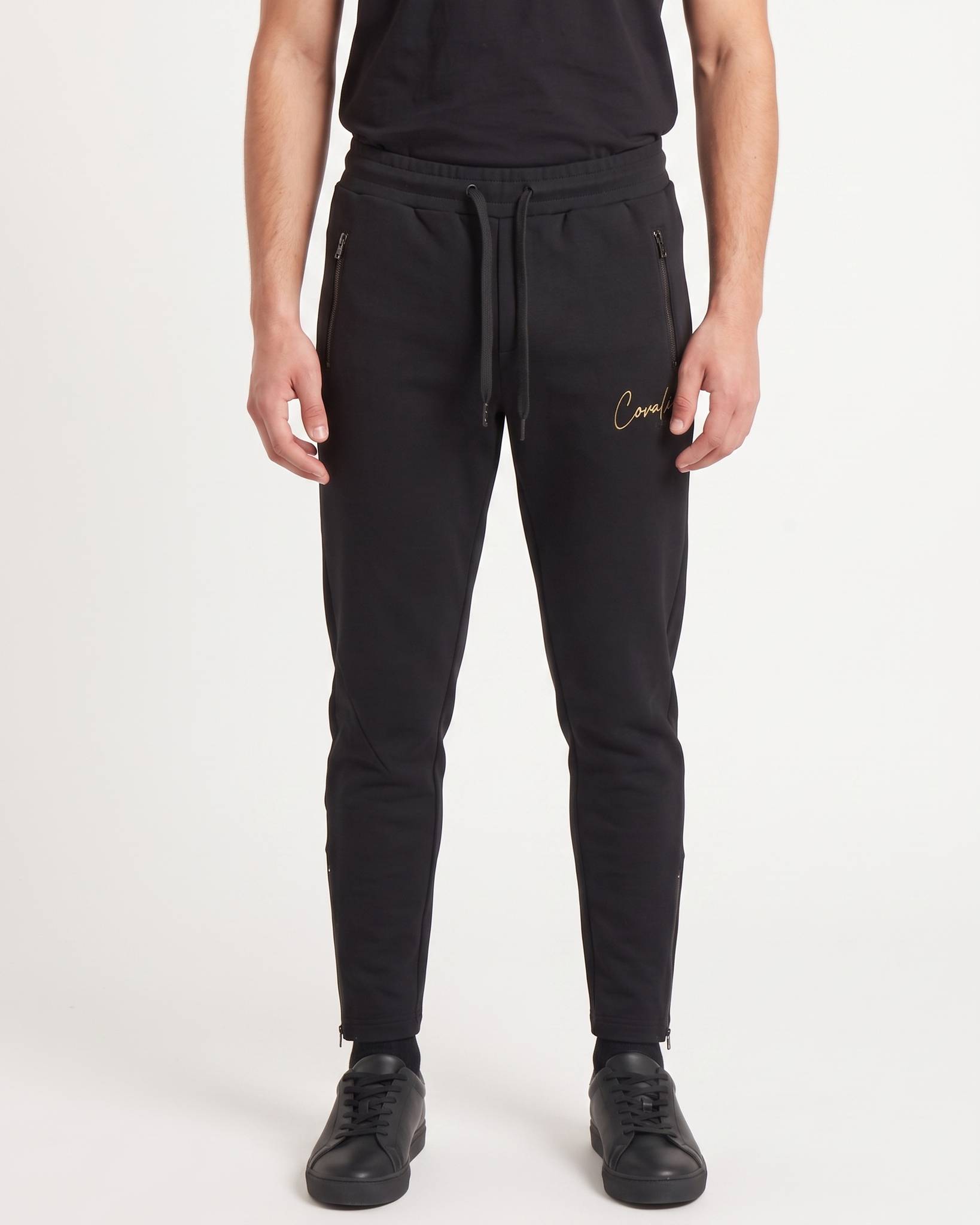 Black Covali Nero-SP men's sweatpants, featuring a drawstring waist and zippered pockets, presented on a full-body model.