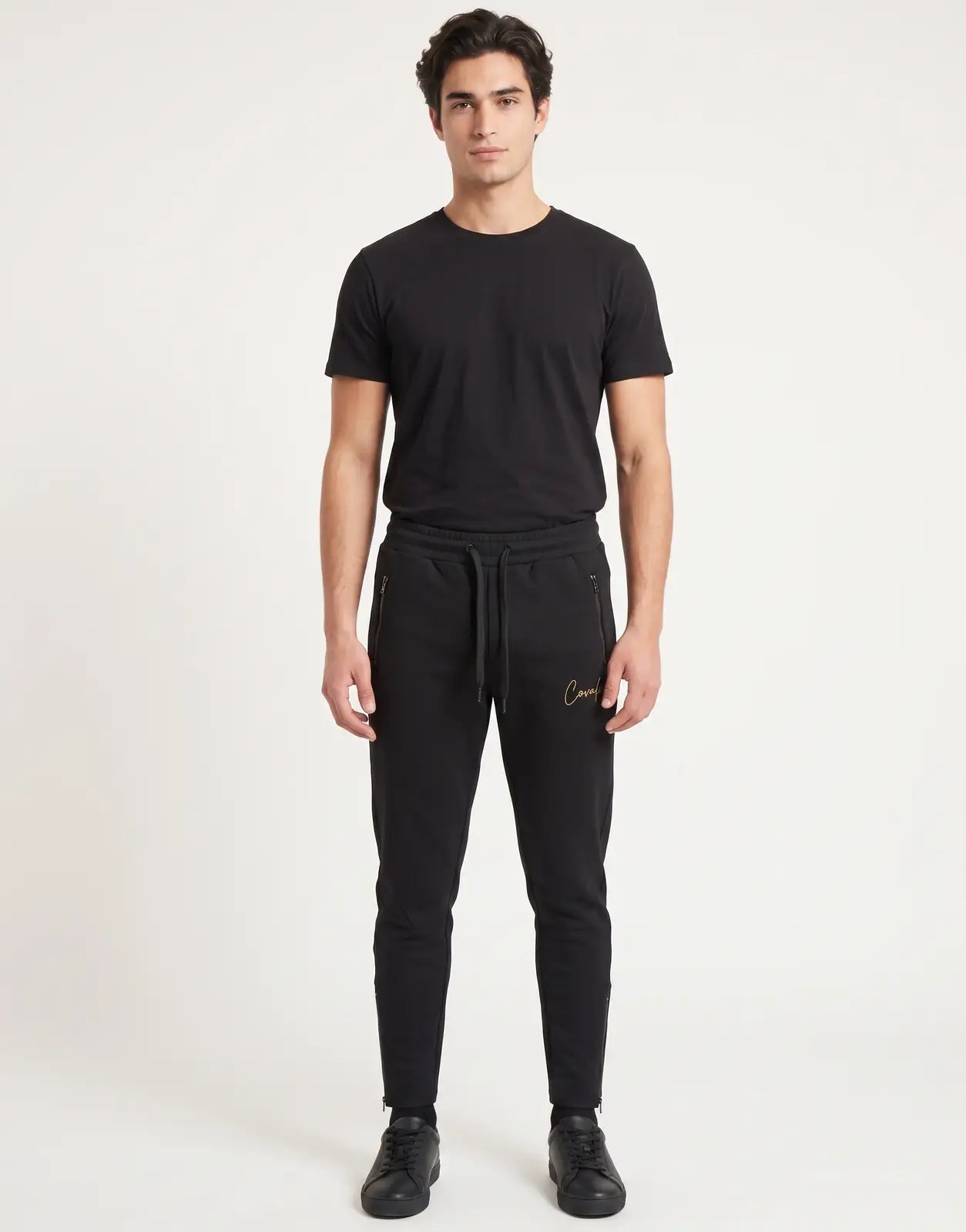 Black Covali Nero-SP Sweatpants for men, featuring a gold logo and zippered pockets, presented in a front view on a male